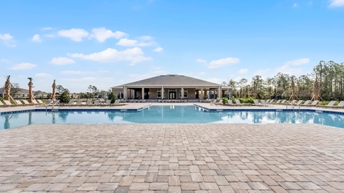 Sunny day at the community swimming pool with lounge seating.