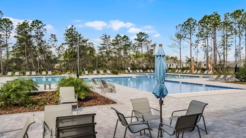 Cool off in the gated community pool, surrounded by lush landscaping