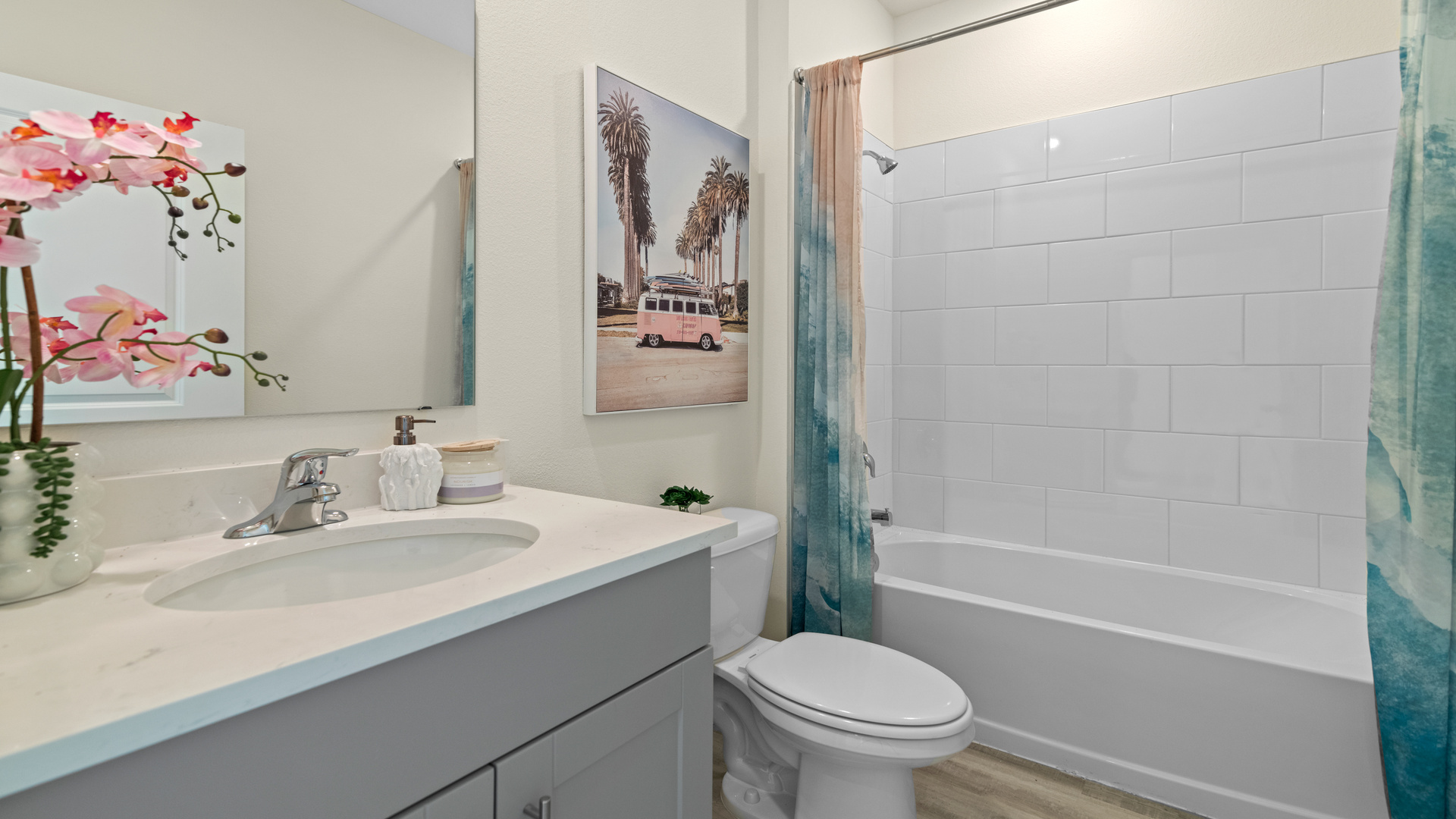 Modern bathroom with double vanity, large wall mirror, cabinets and quartz countertops