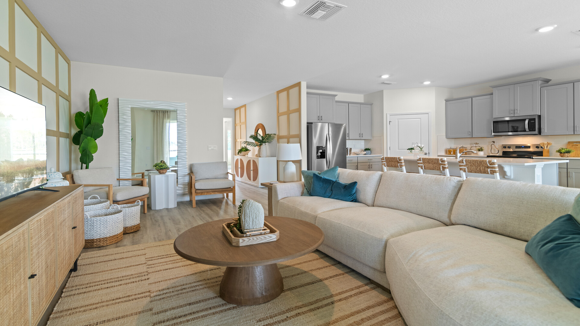 Living area with couch seating, entertainment system and natural lighting