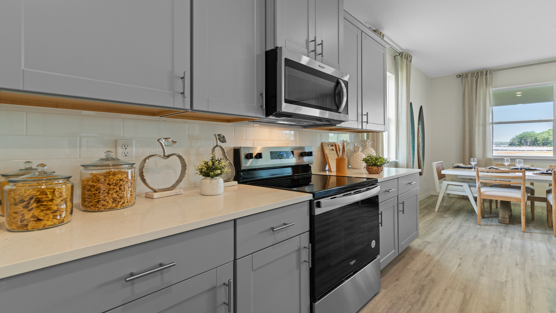 kitchen with quartz countertops overseeing living area and dining room table