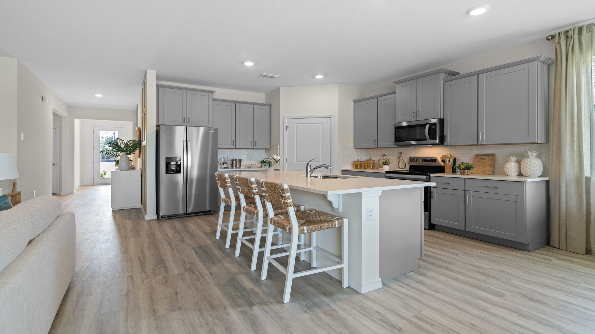 kitchen with quartz countertops overseeing living area and dining room table