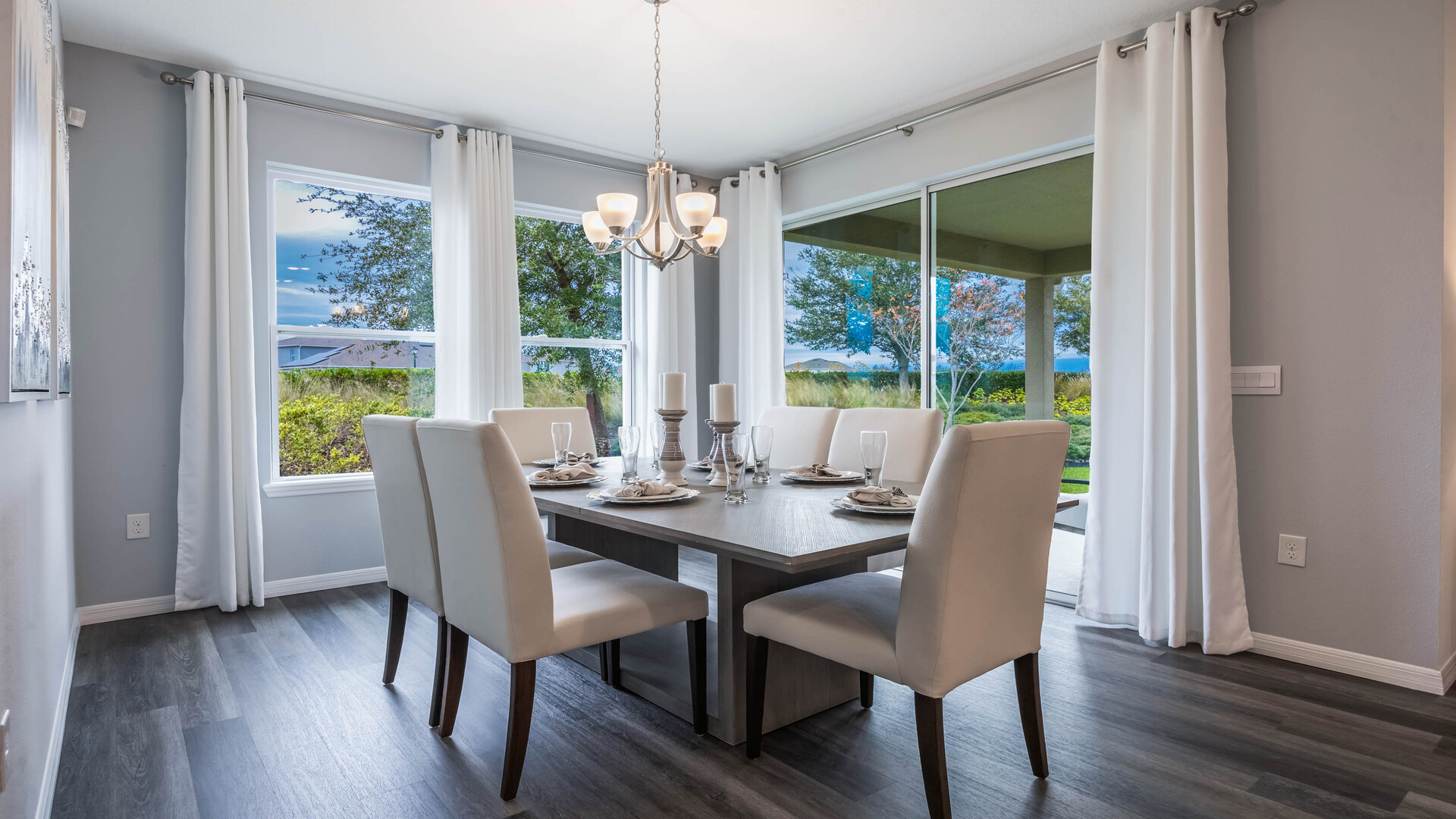 Dining room area with table, seating and natural lighting.