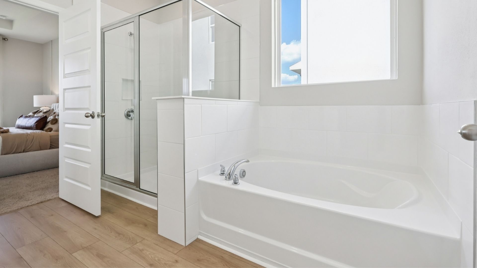 Modern bathroom with single vanity, large wall mirror, cabinets and quartz countertops
