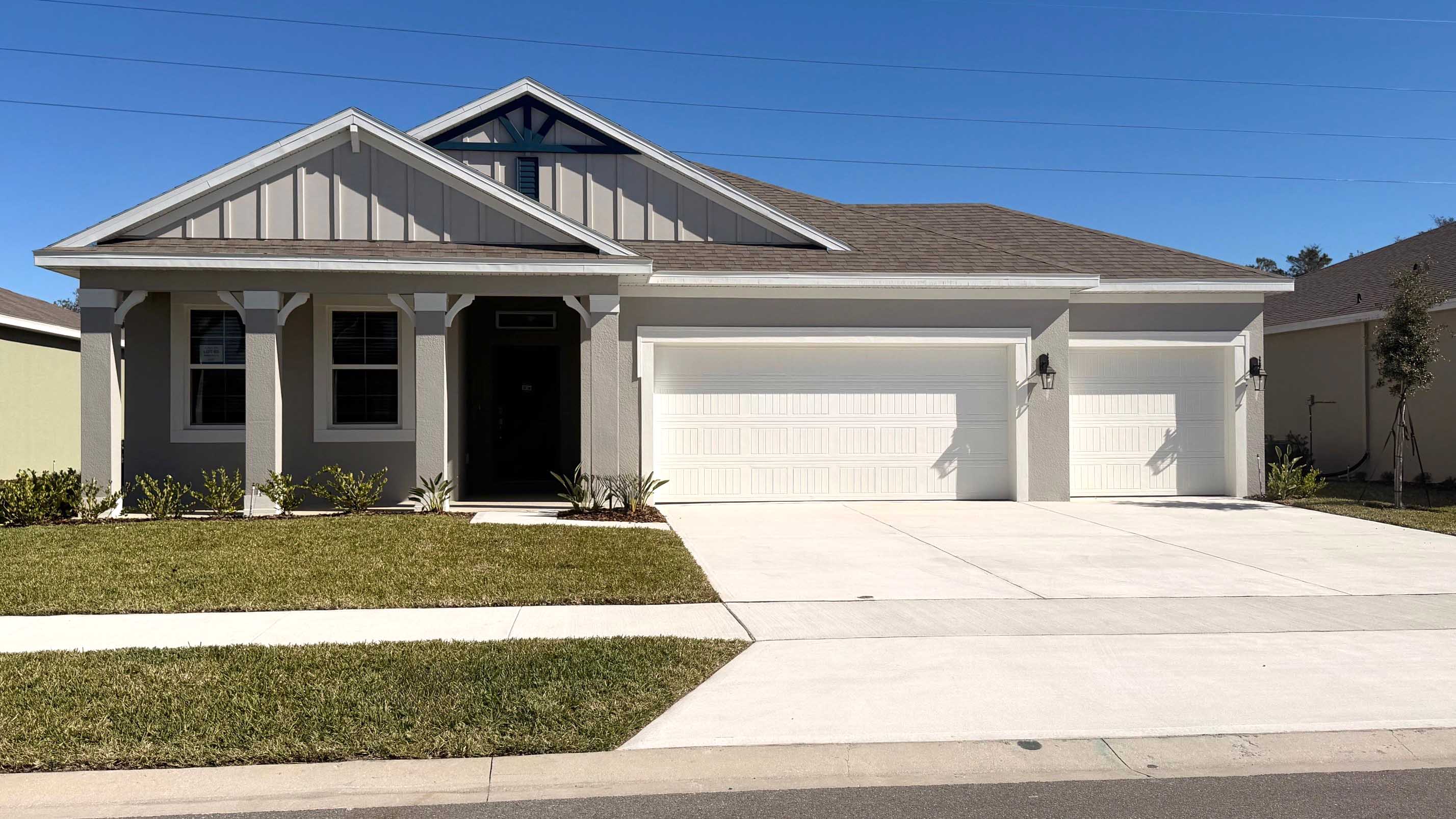 Single story new home with large windows and 2 car garage.