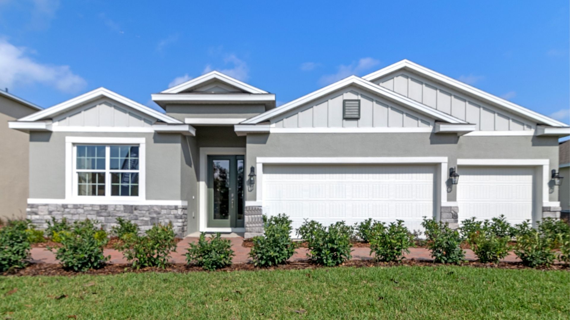 Single story new home with large windows and 2 car garage.