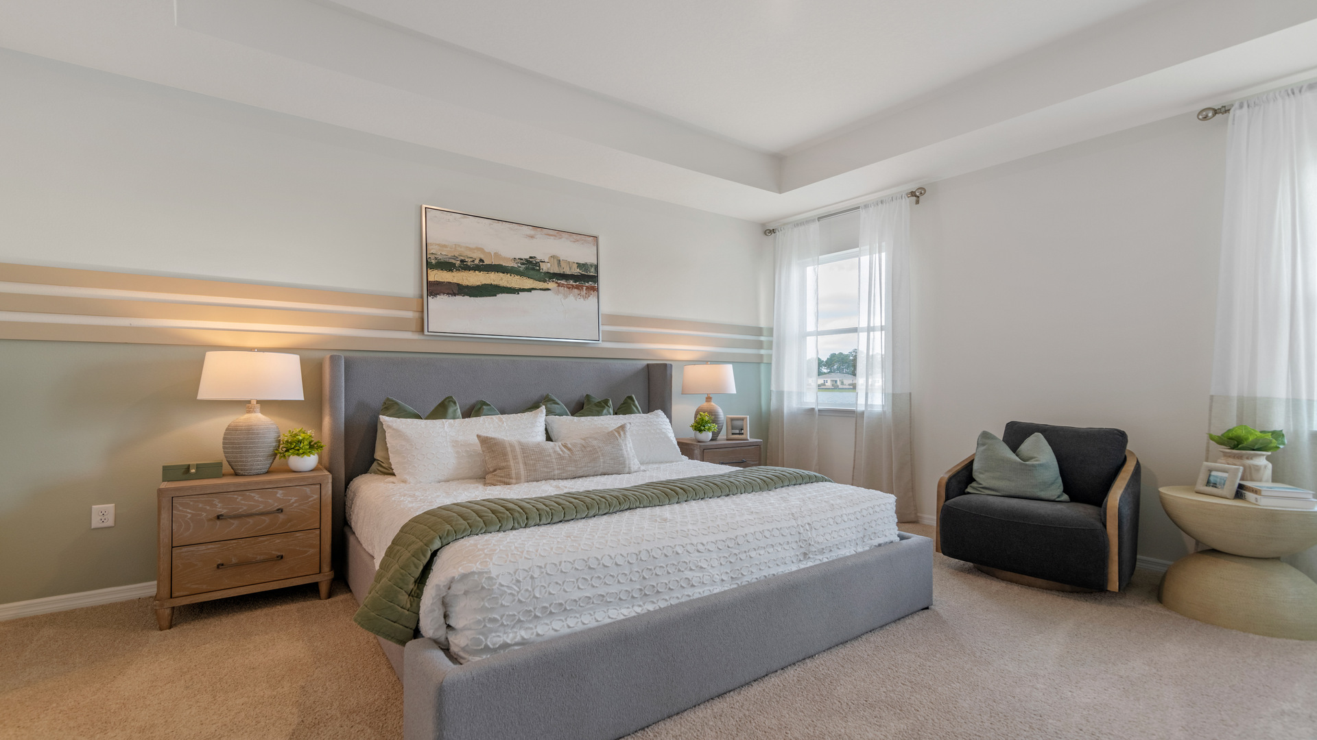 Guest bedroom with bed, nighstands and natural lighting.