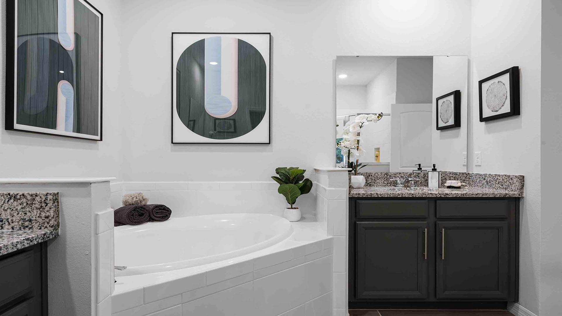 Guest bathroom with single vanity granite countertop, toilet and walk-in shower.