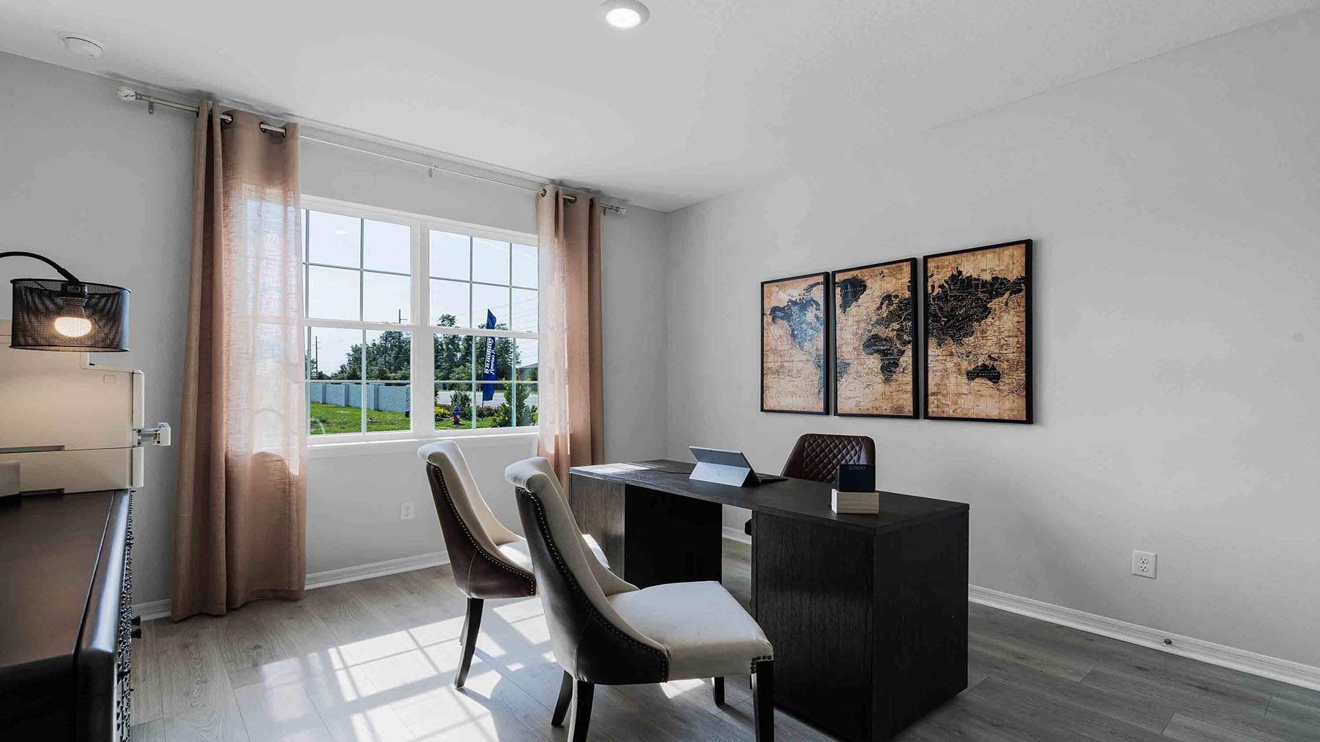 Functional home office with desk, chairs and space to work or play.