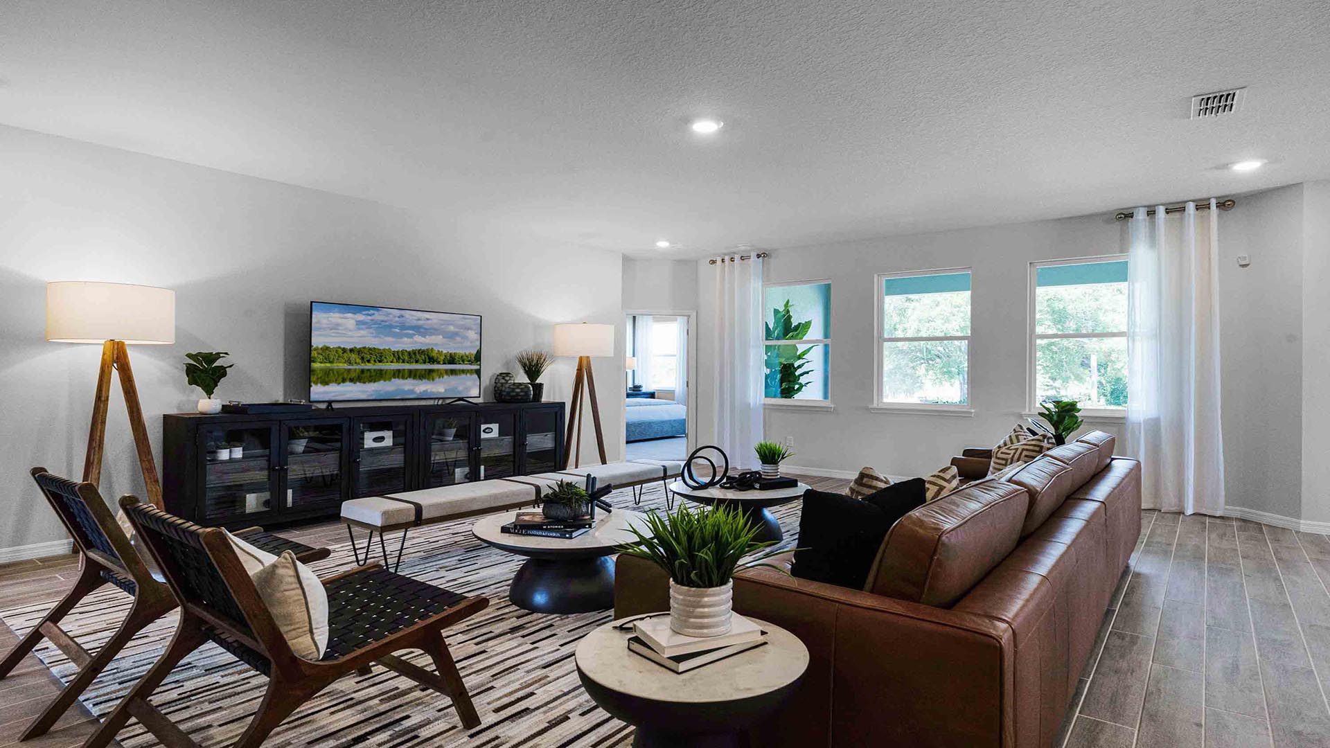 living area with couch seating and entertainment system adjacent to kitchen.