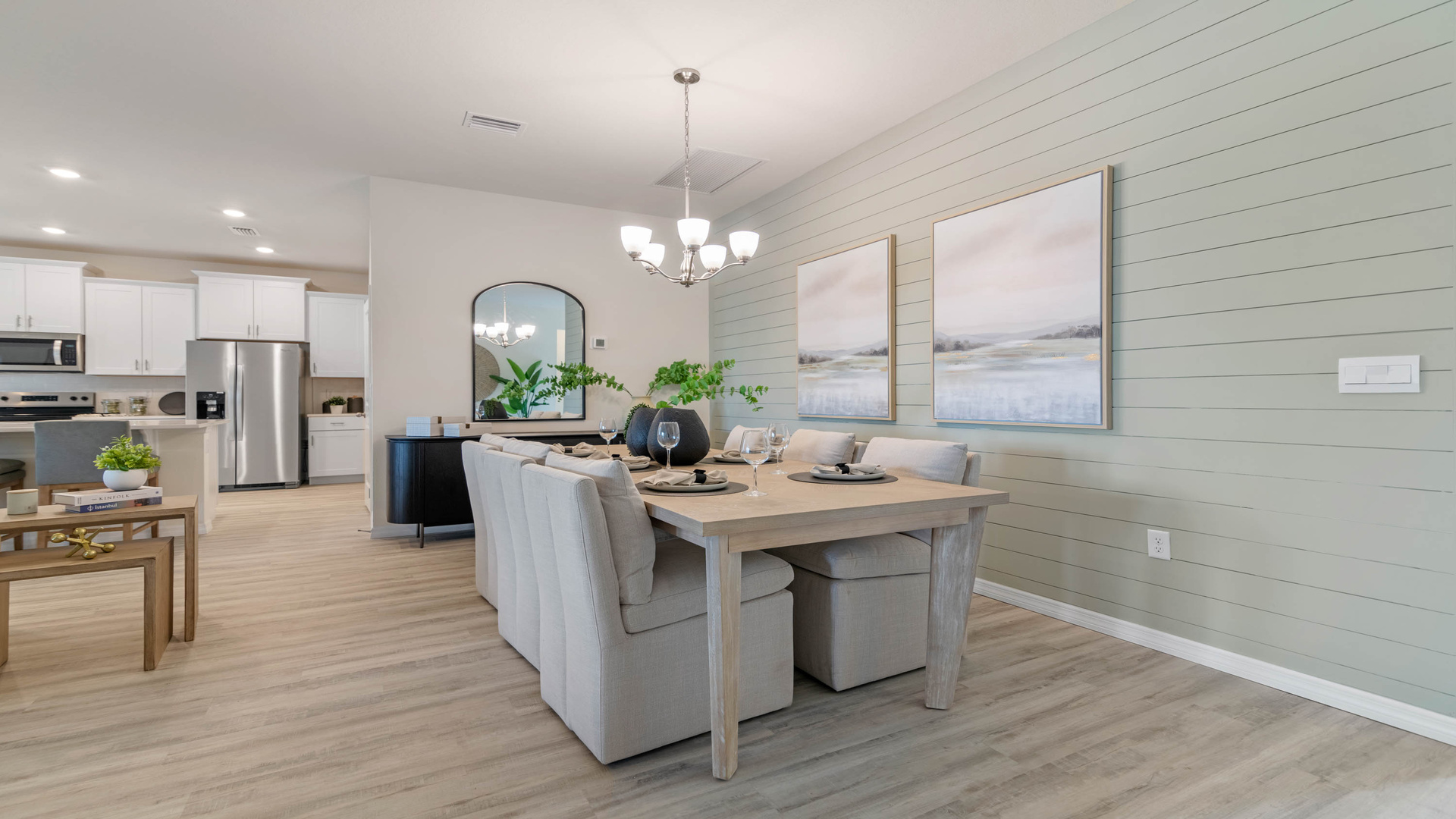Dining room adjacent to the kitchen with table, chairs and tile flooring.