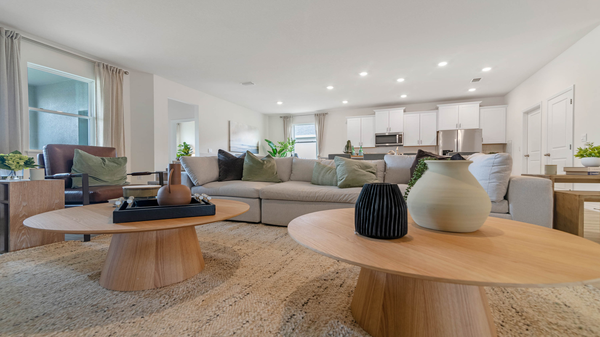 Open concept living area with couch seating and access to the backyard thru slider door.