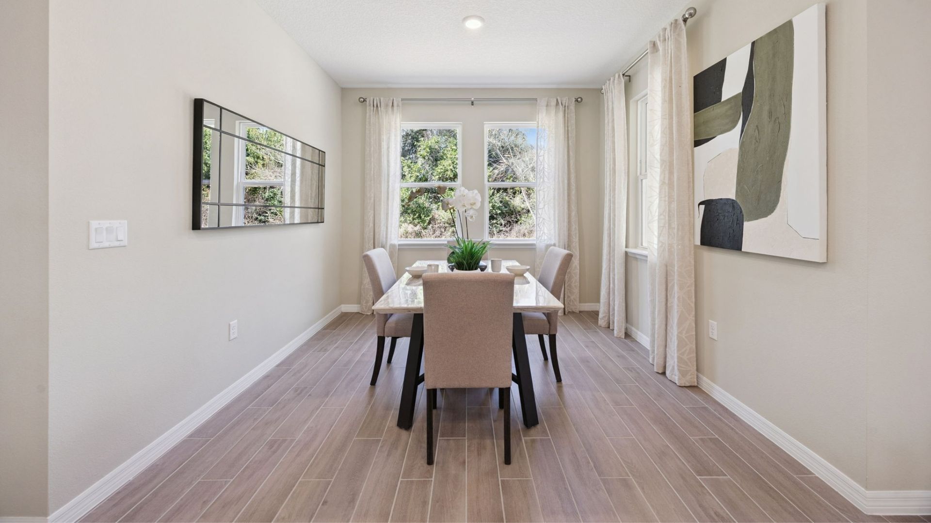 Dining room table with natural lighting and seating.