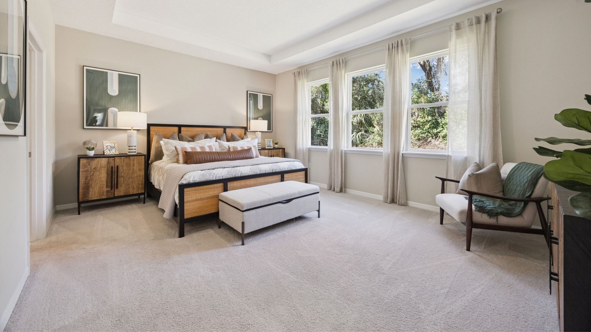 Guest bedroom with bed, nighstand, desk, and natural lighting.