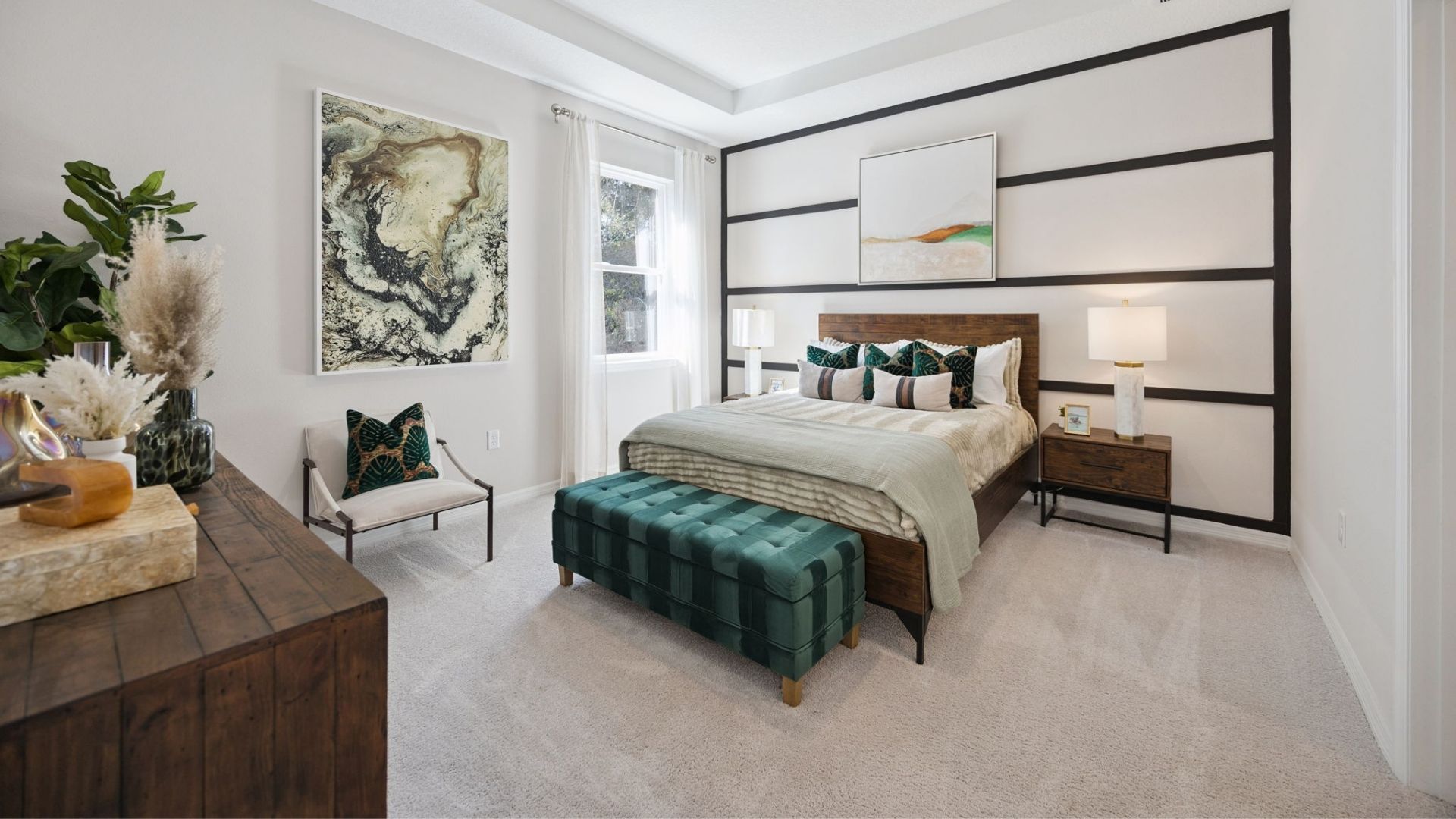 Guest bedroom with bed, nighstand, desk, and natural lighting.