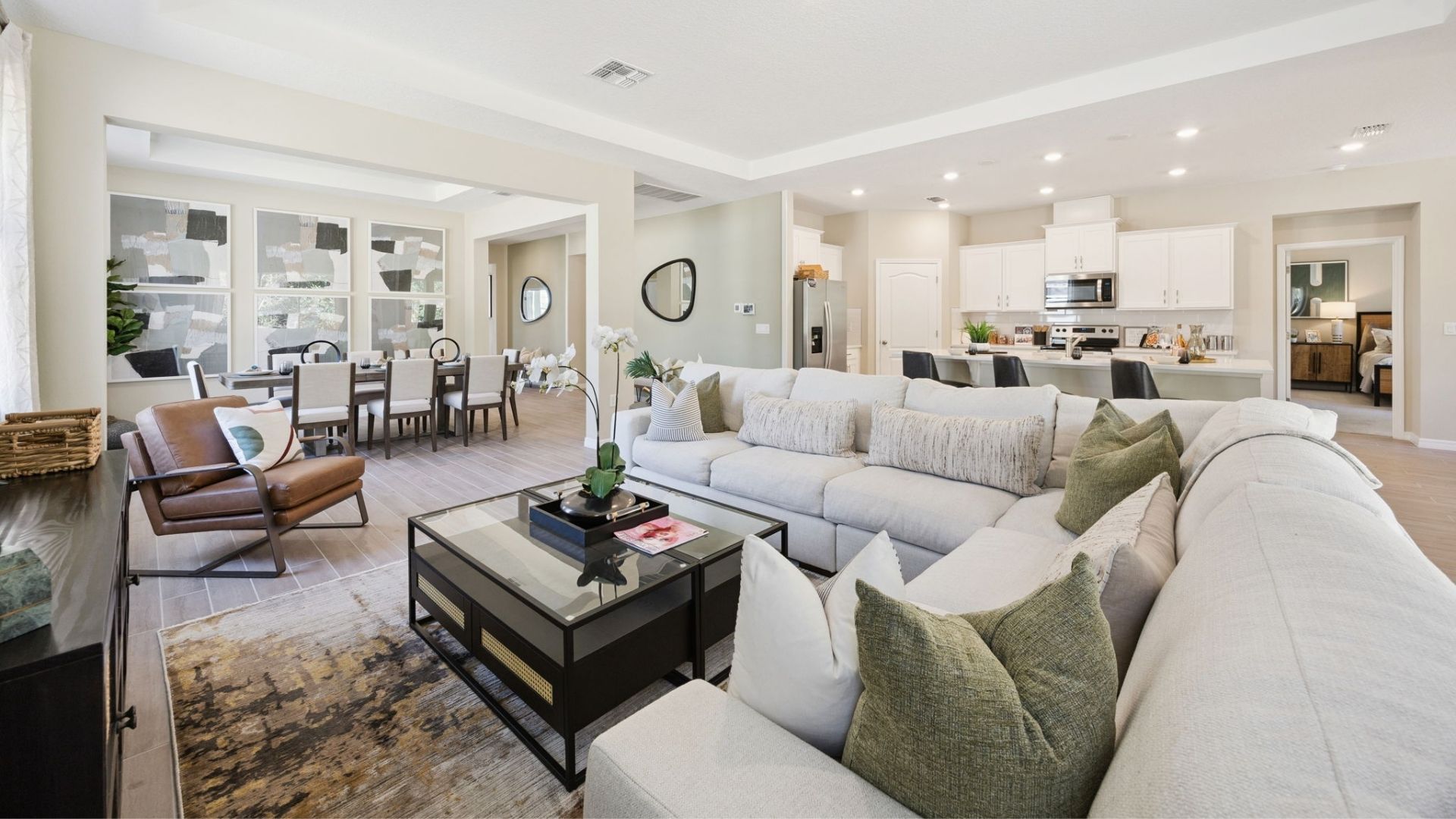 Living area with couch seating, entertainment system and natural lighting