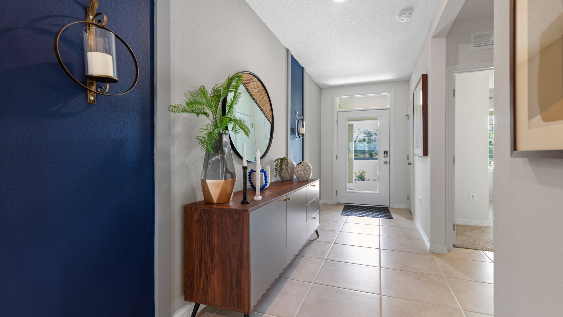 Home entry way thru the front door with tile flooring and a view to the living space.