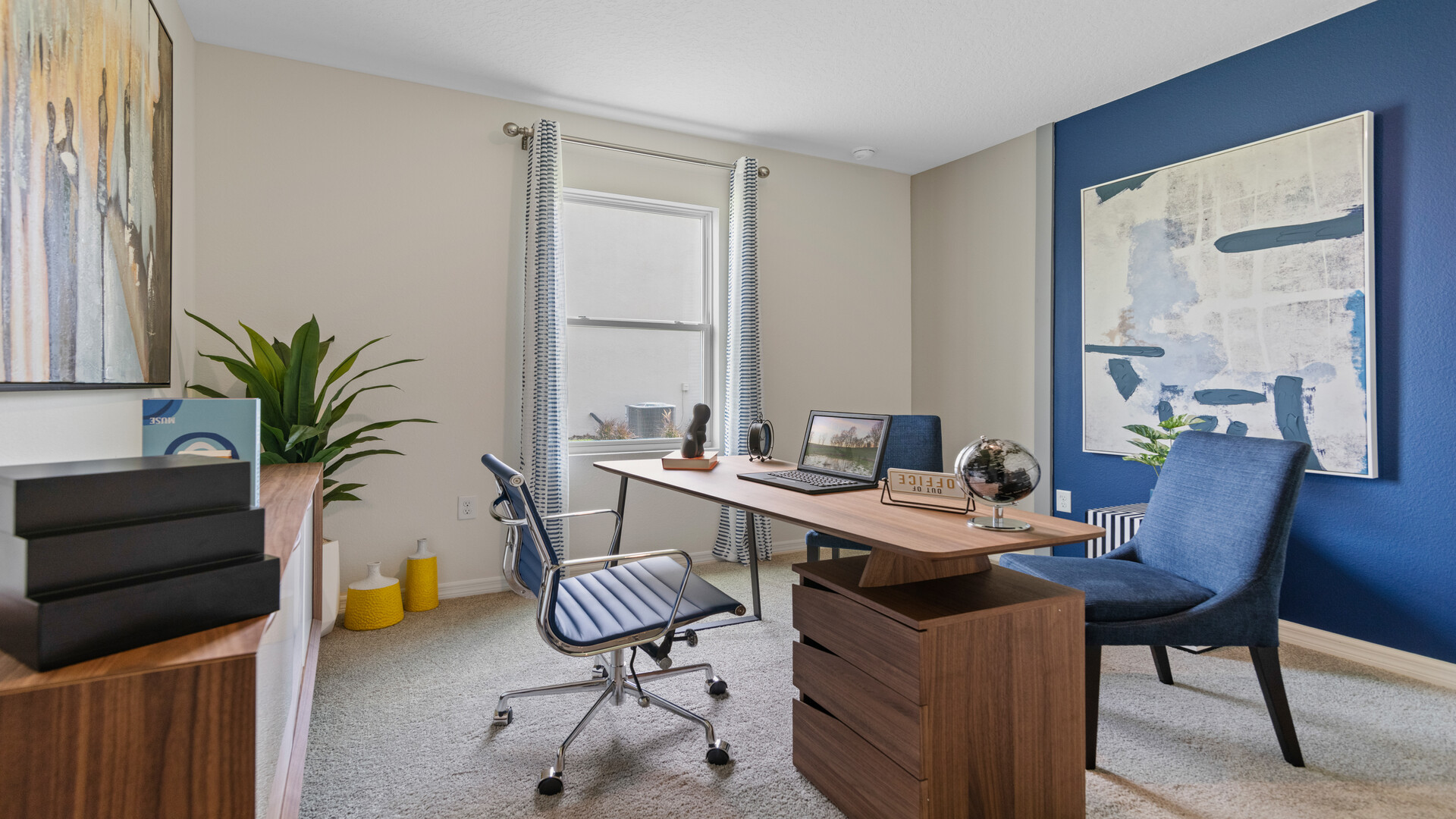 Functional home office with desk, chairs and space to work or play.