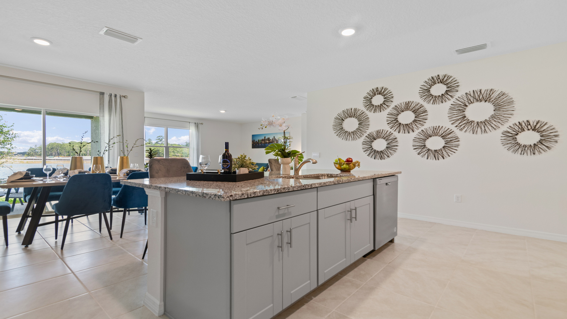 Kitchen with island seating, granite counters, spacious pantry and stainless-steel appliances.