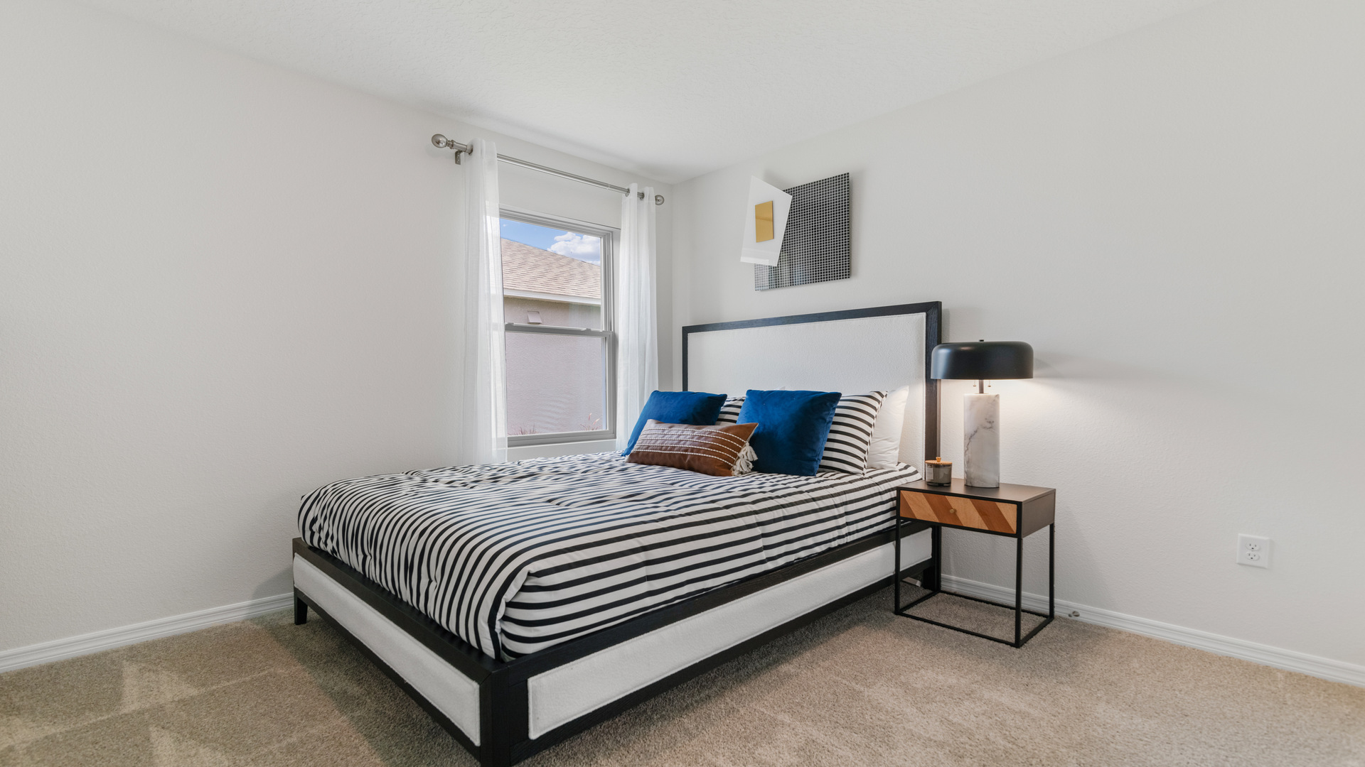 Guest bedroom with bed, nightstands and a roomy closet for storage.