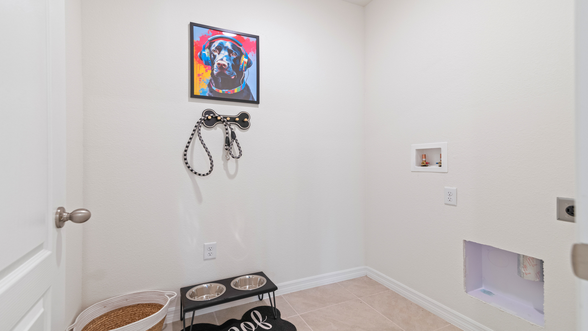 Laundry room with washer and dryer hookups and wall shelving.