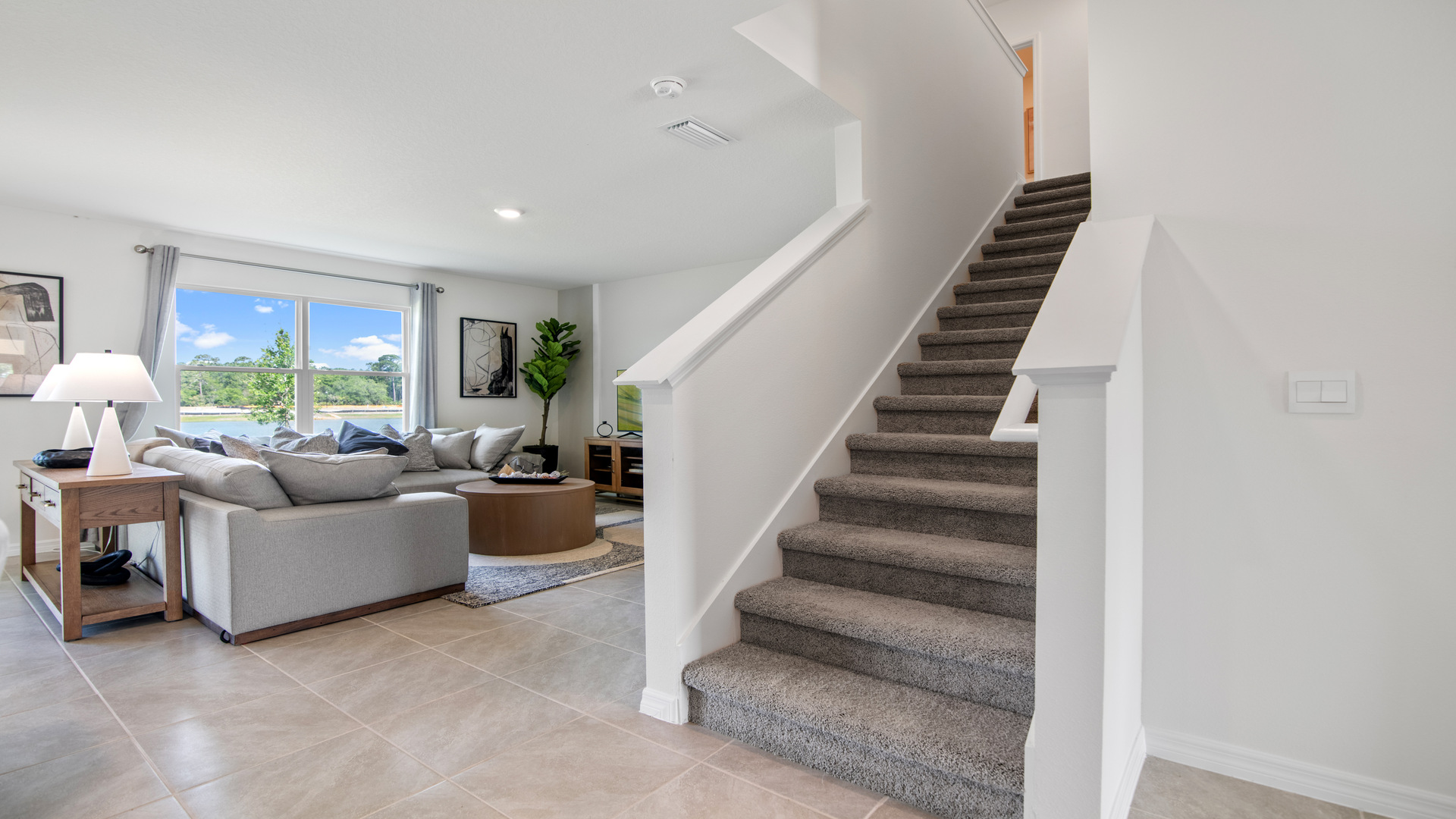 Home entry way thru the front door with tile flooring and a view to the living space.