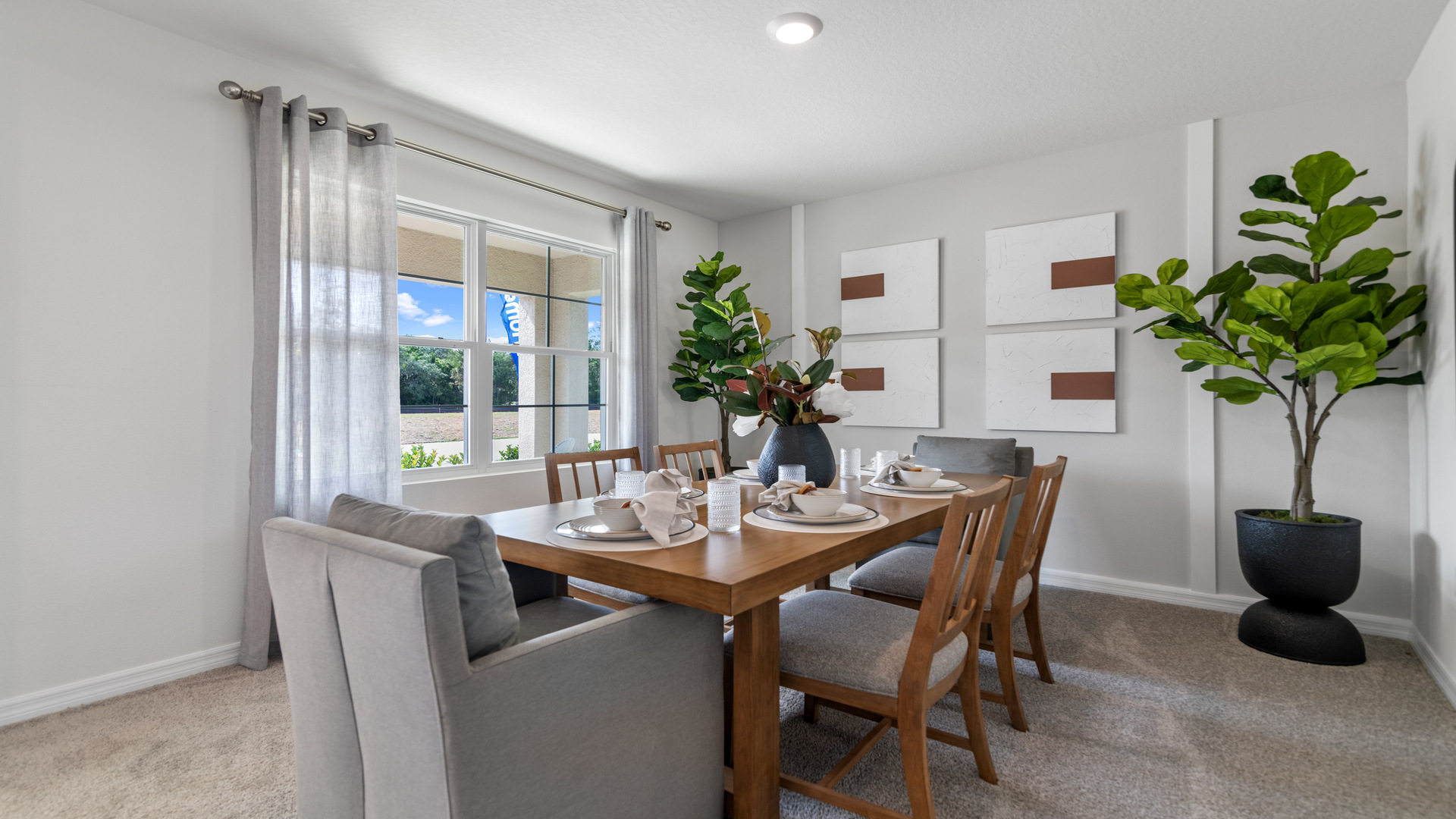 Dining room adjacent to the kitchen with table, chairs and tile flooring.