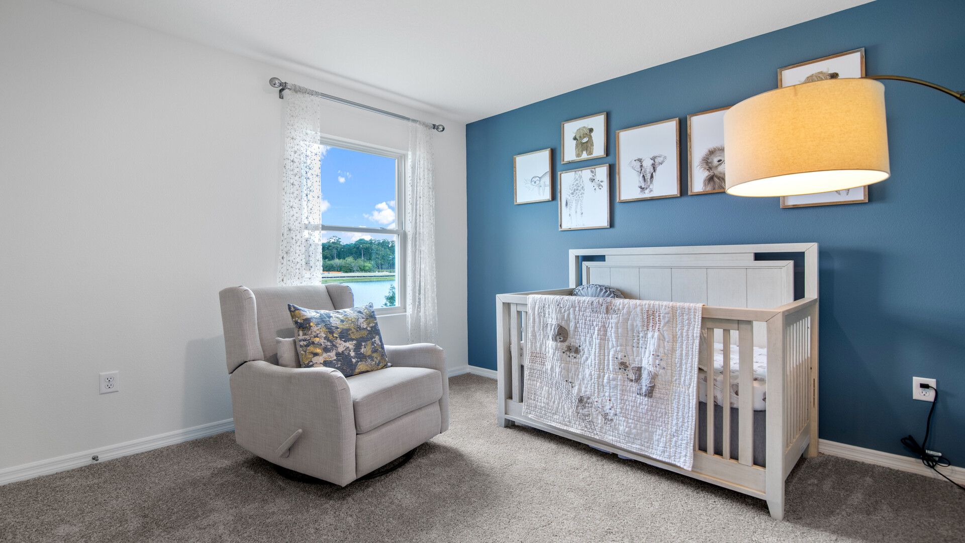 Child's nursery with crib, closet, soft seating and storage.