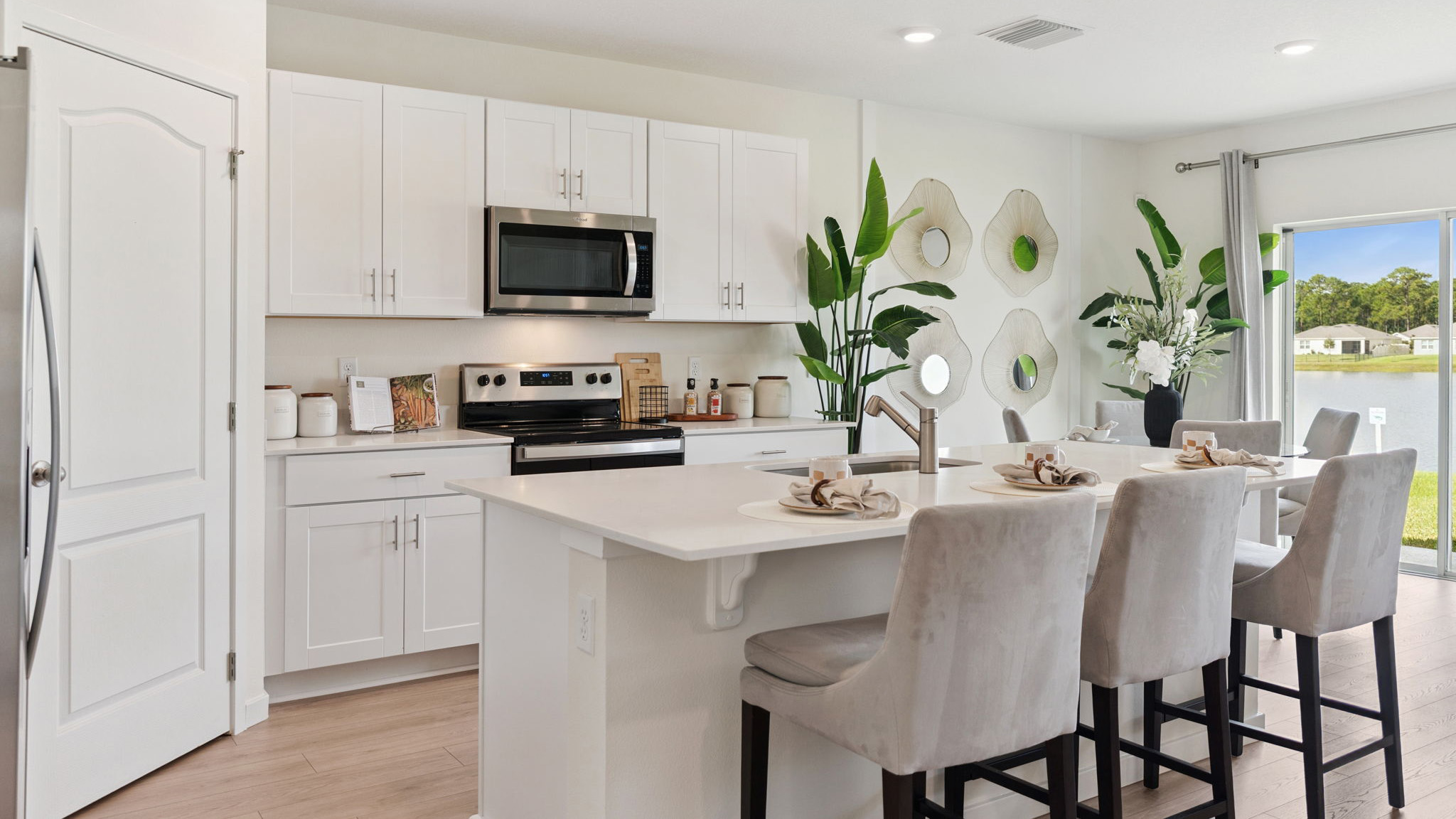 Kitchen with tall cabinetry, appliances, walk in pantry and Luxury vinyl plank flooring.