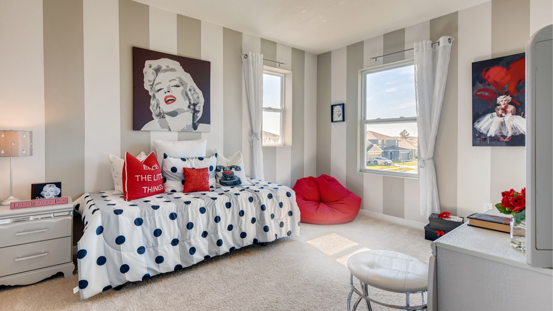Child's room with toys, bedding, seating and storage and a spacious closet.