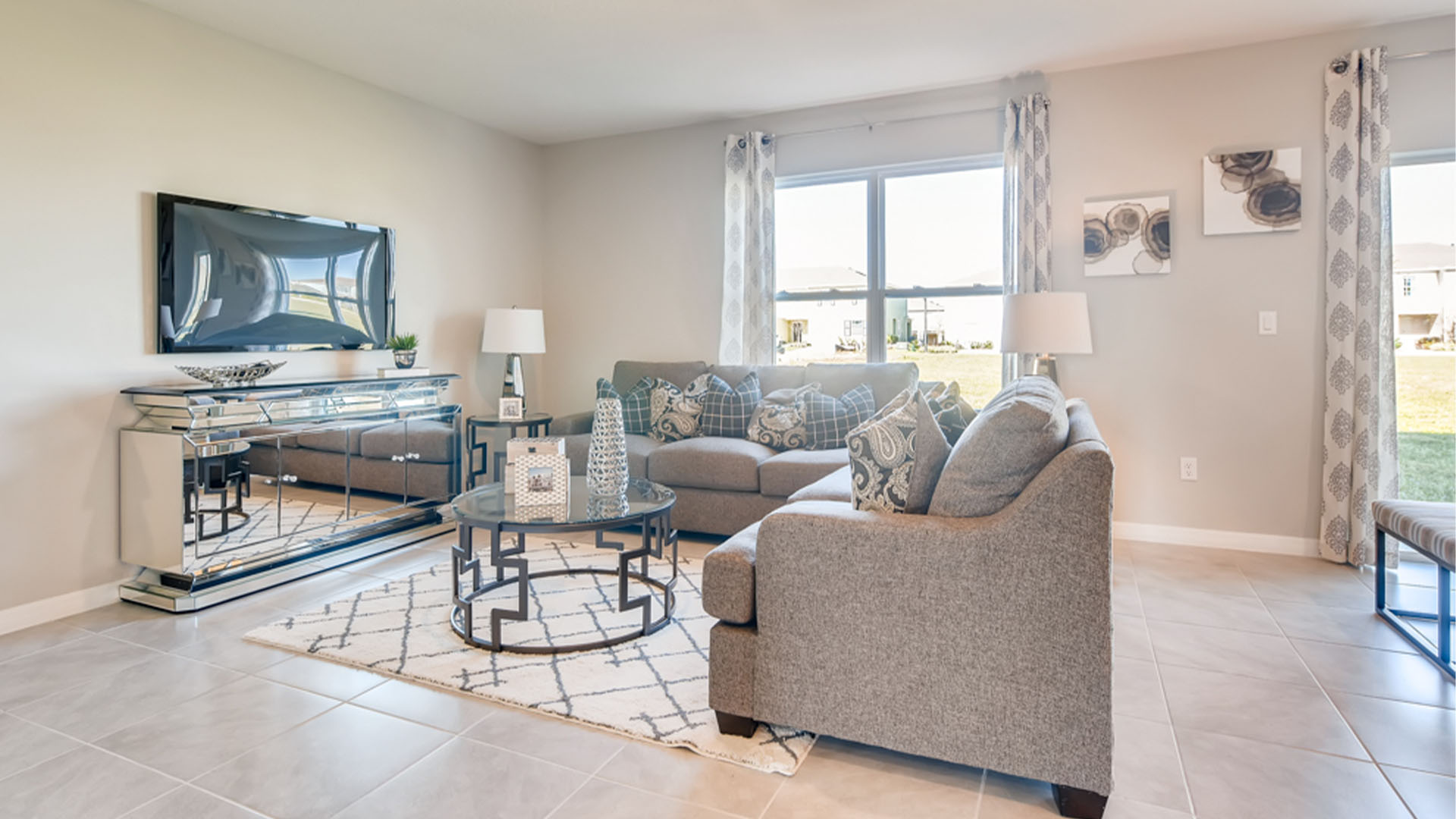 Open concept living area with couch seating and access to the backyard thru slider door.