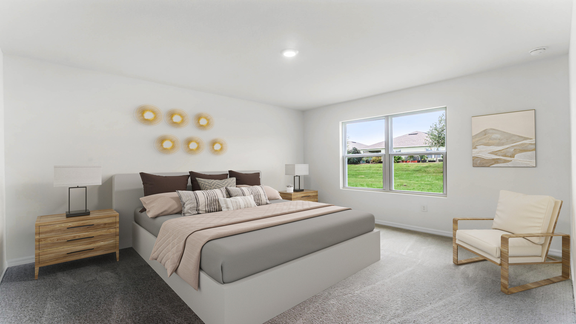 Spacious primary bedroom with king size bed, carpet flooring, natural lighting.