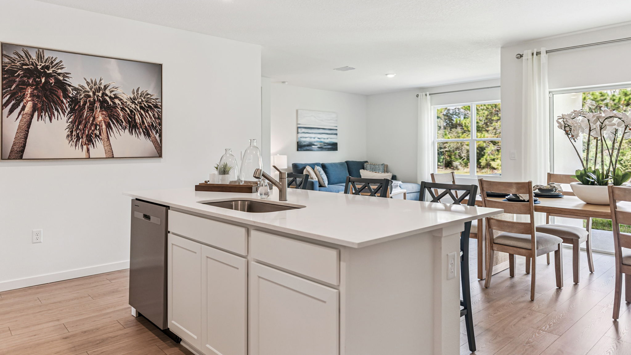 Living area with couch seating, entertainment system and natural lighting