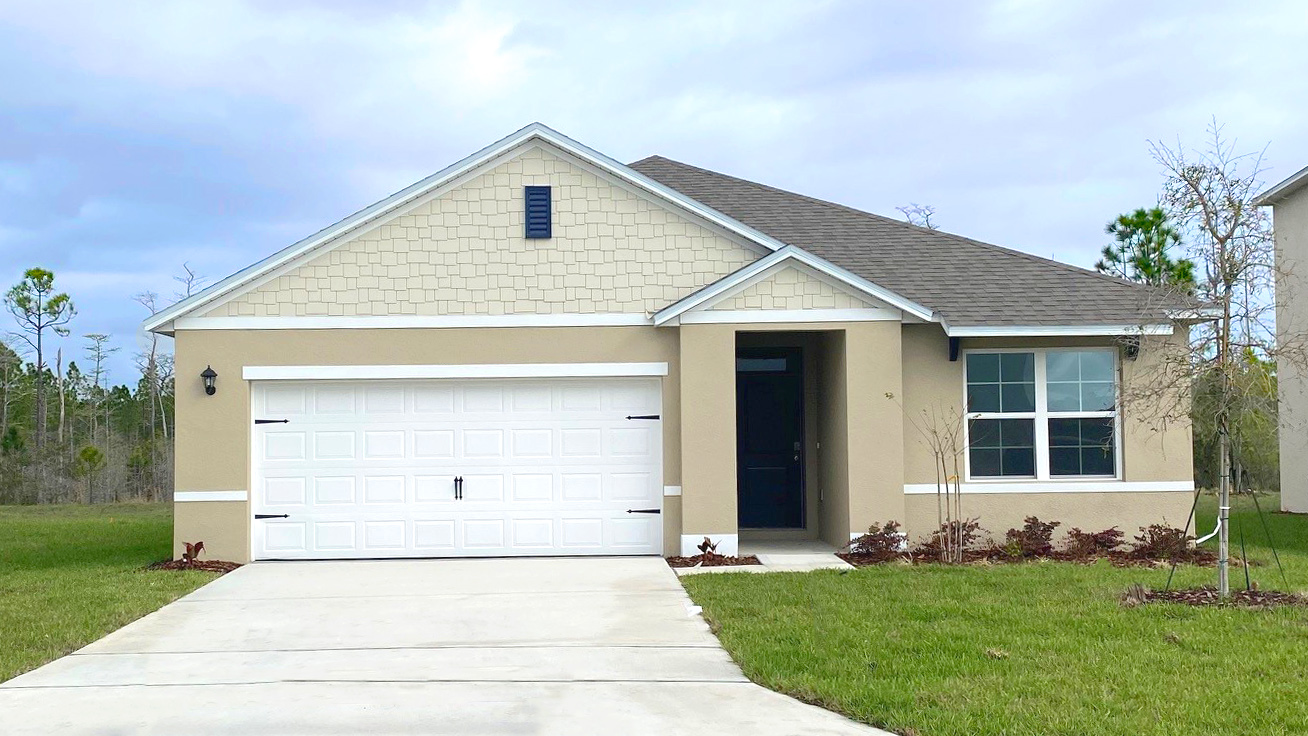 Single story new home with large windows and 2 car garage.