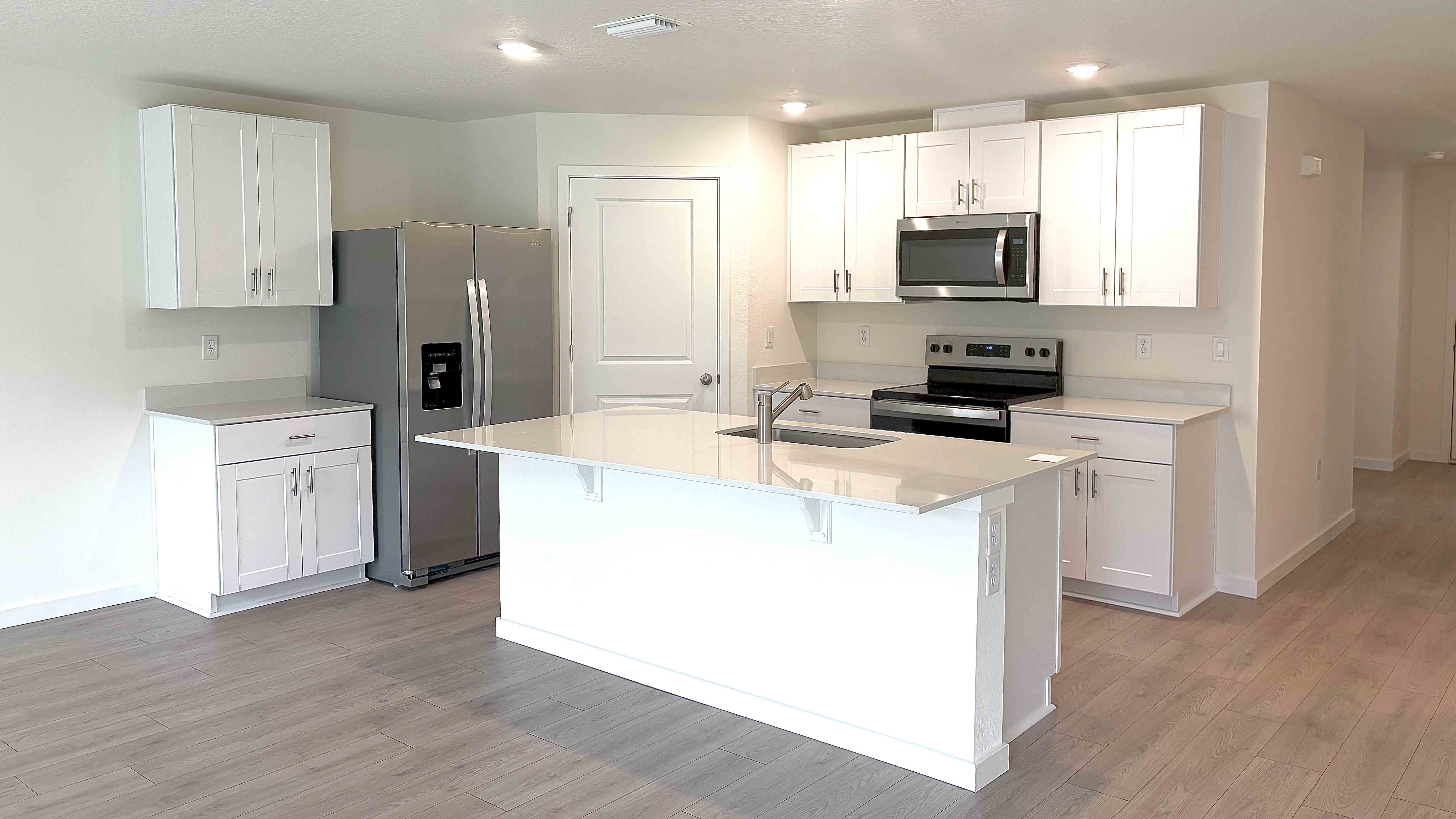 kitchen with white quartz and cabinets