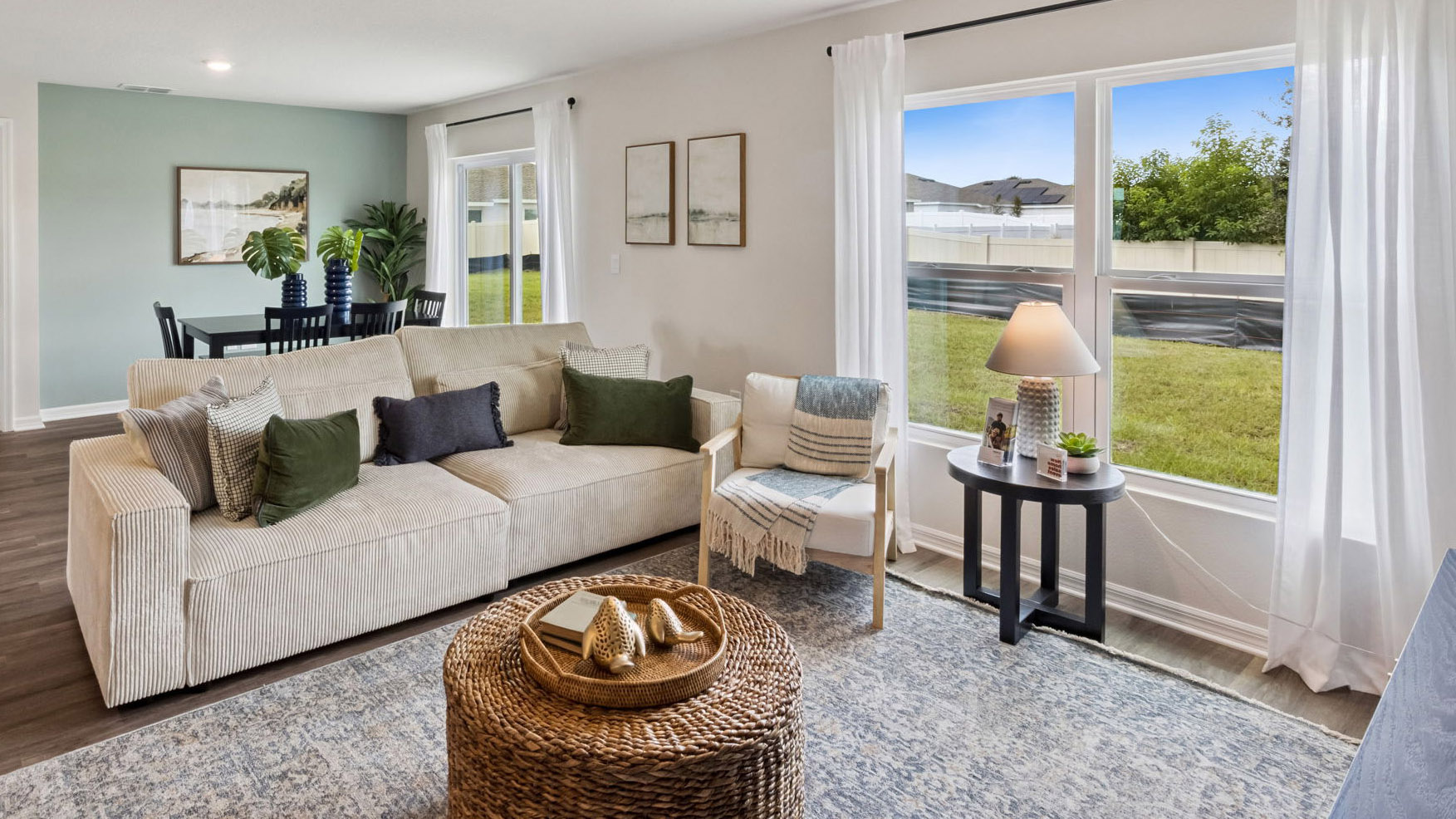 Living area with couch seating, entertainment system and natural lighting