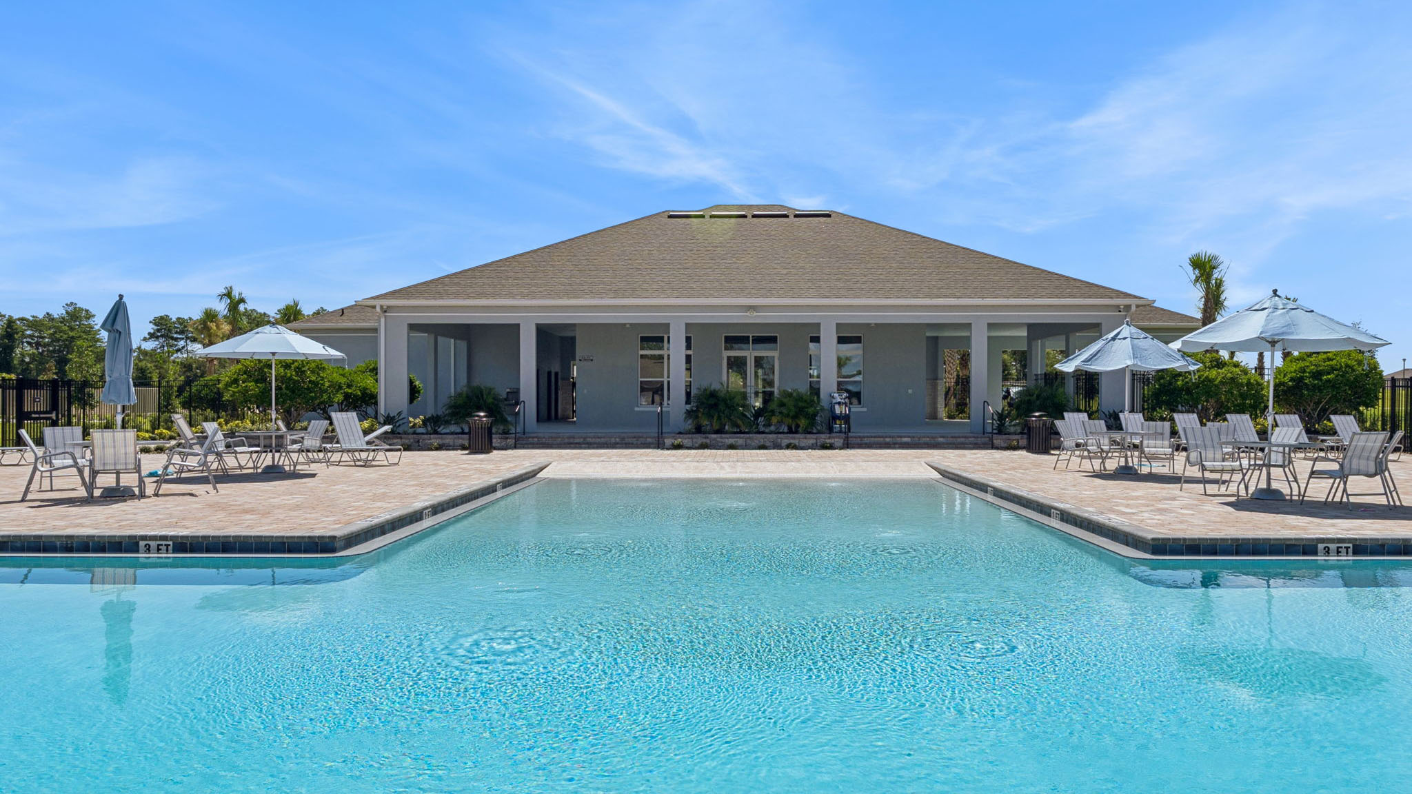 Pool house view with lounge chairs
