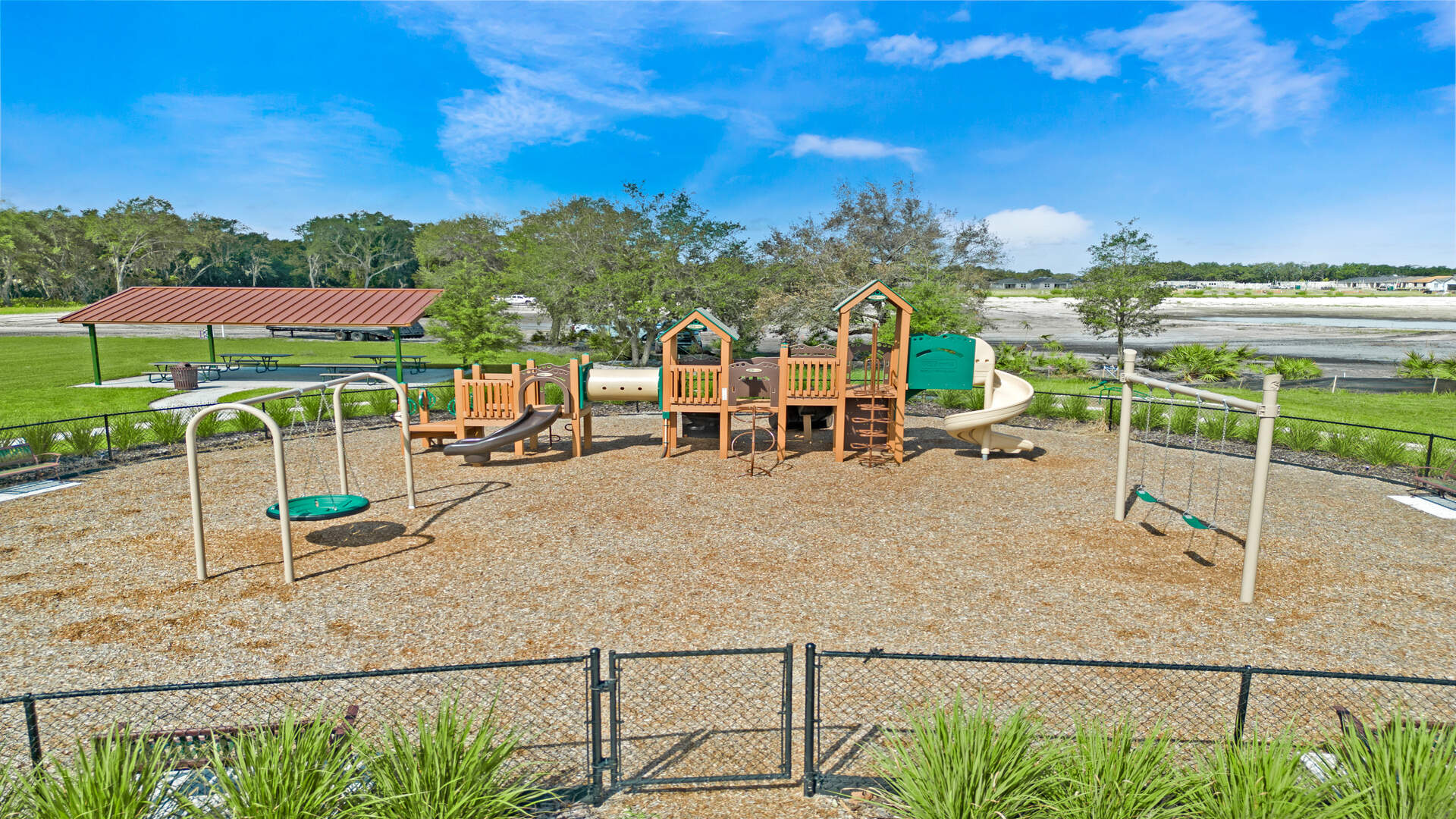 Enjoyment children's playground with mulched ground and climbing equipment.