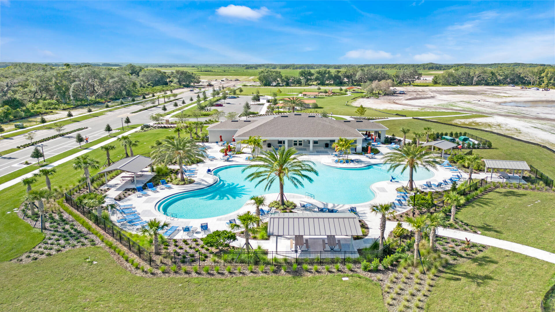 Birds eye view of the community swimming pool with lounge seating.