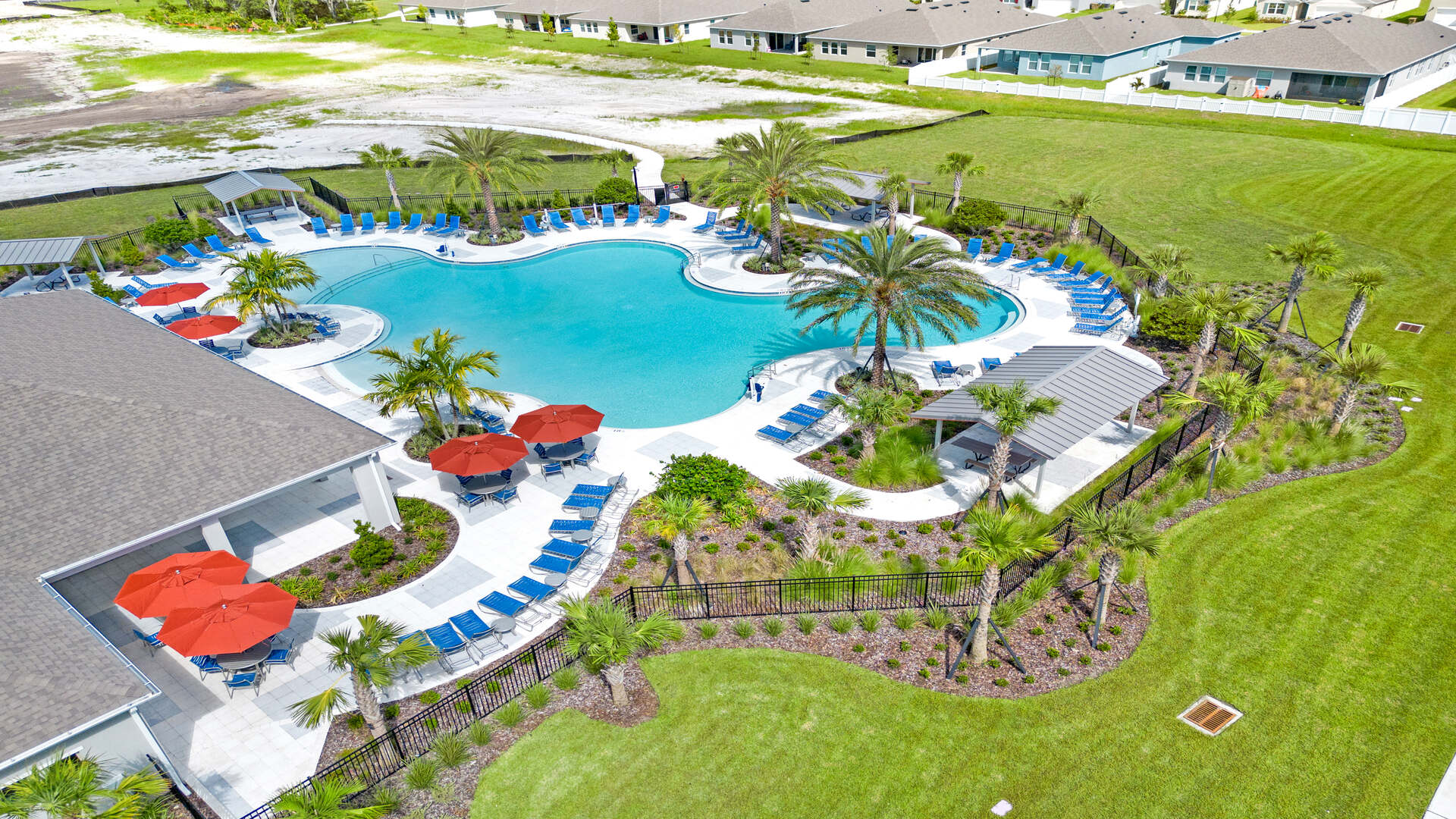 Sunny day at the community swimming pool with lounge seating.