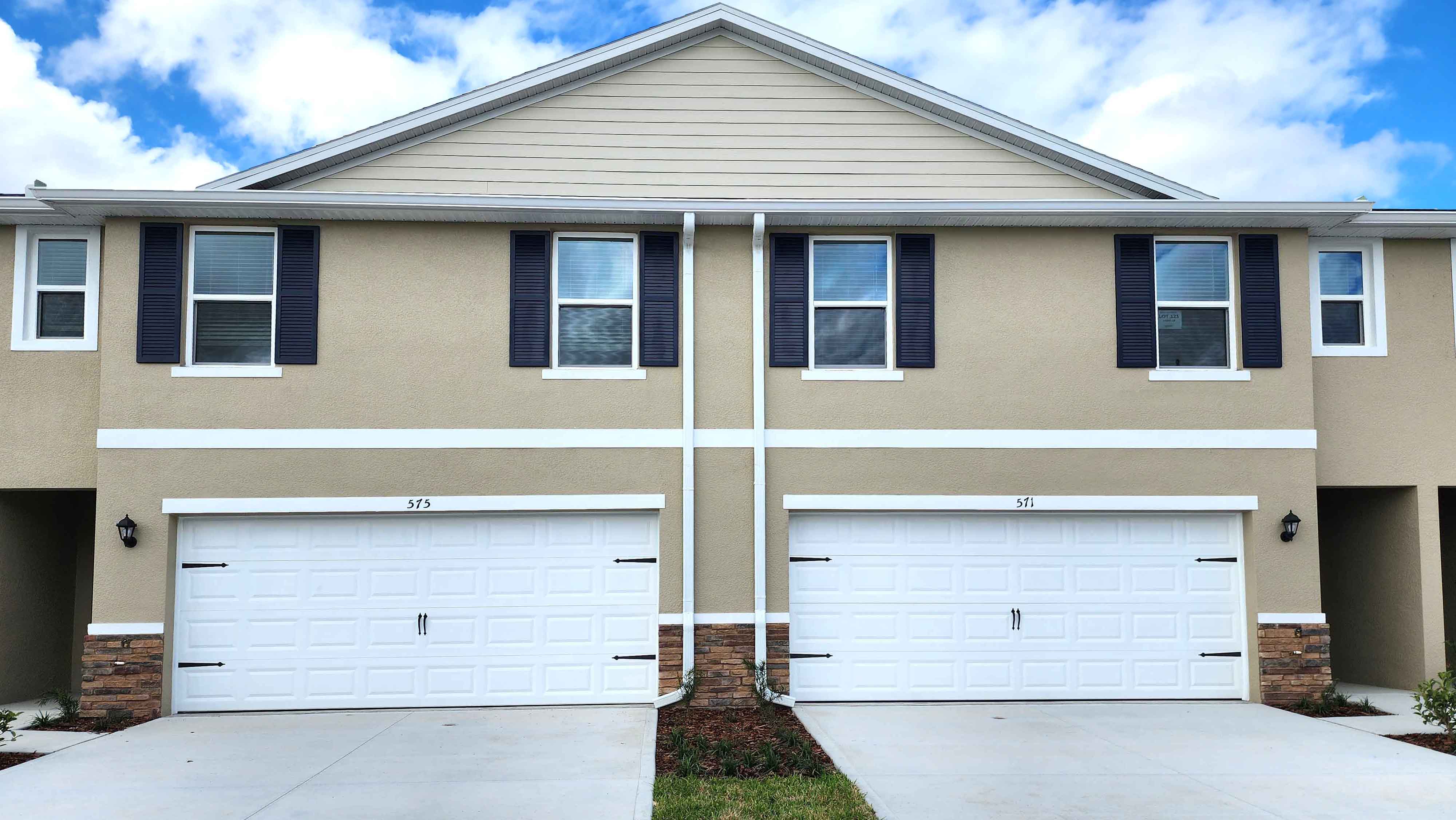 Attached townhome with concrete block construction and a one-car garage.