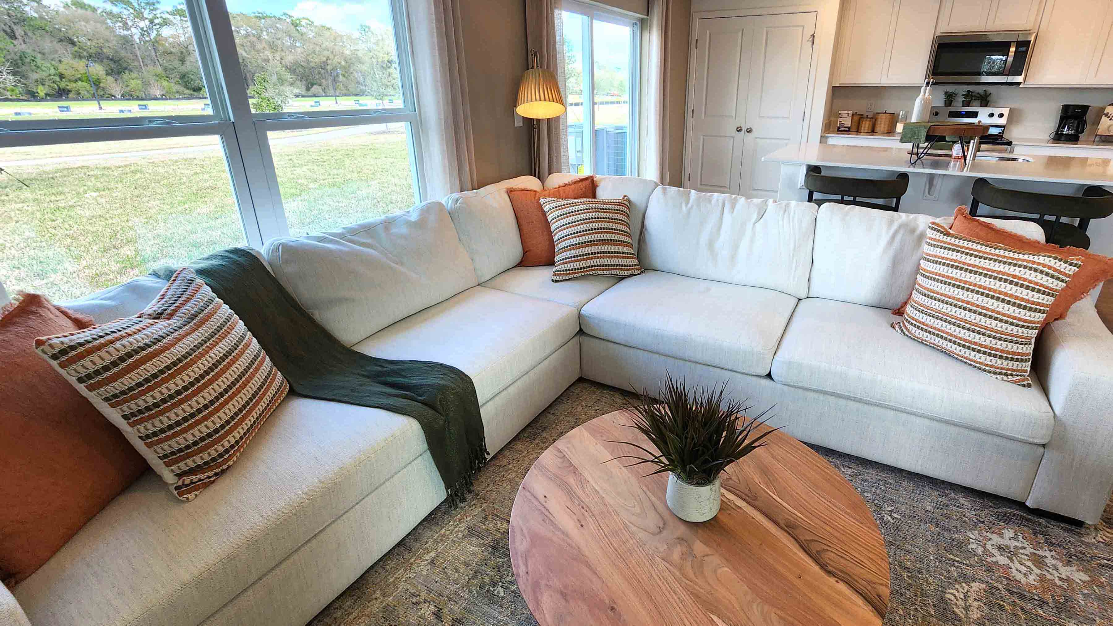 Living area with couch seating and natural lighting next to access to Master Bedroom.