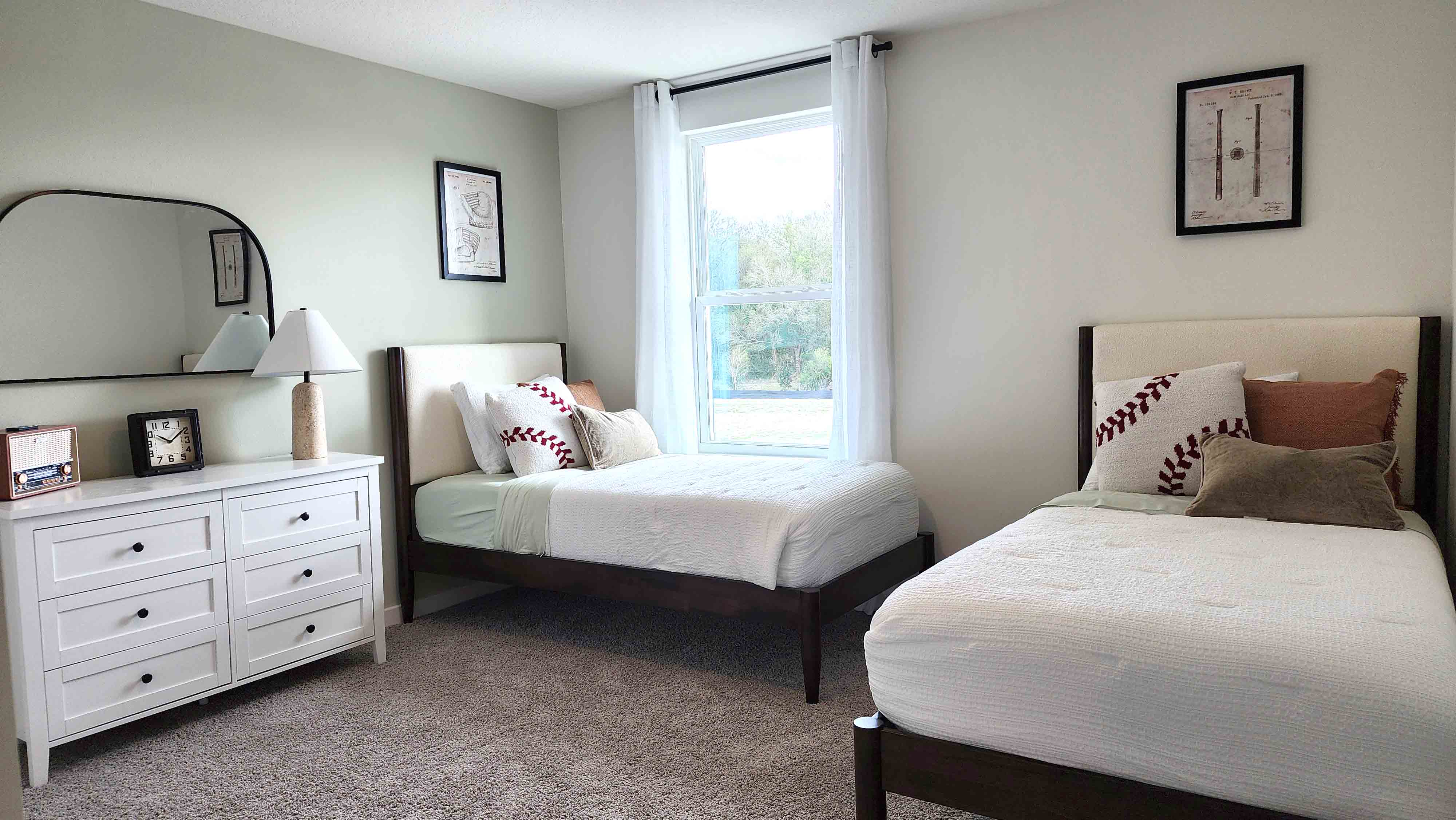 Guest bedroom with bed, nighstands and natural lighting and spacious closet.