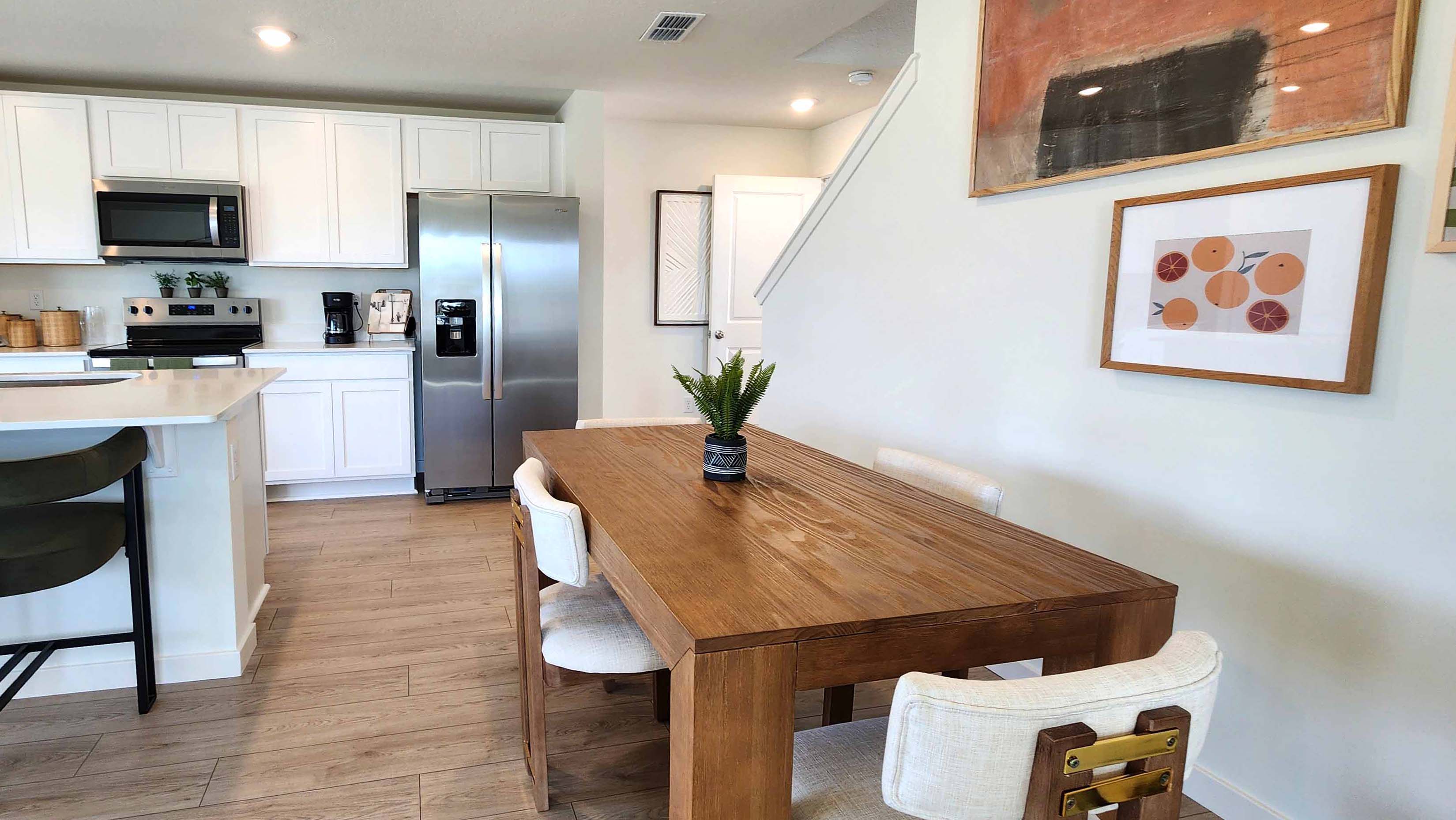 Dining room area with table, seating and natural lighting.