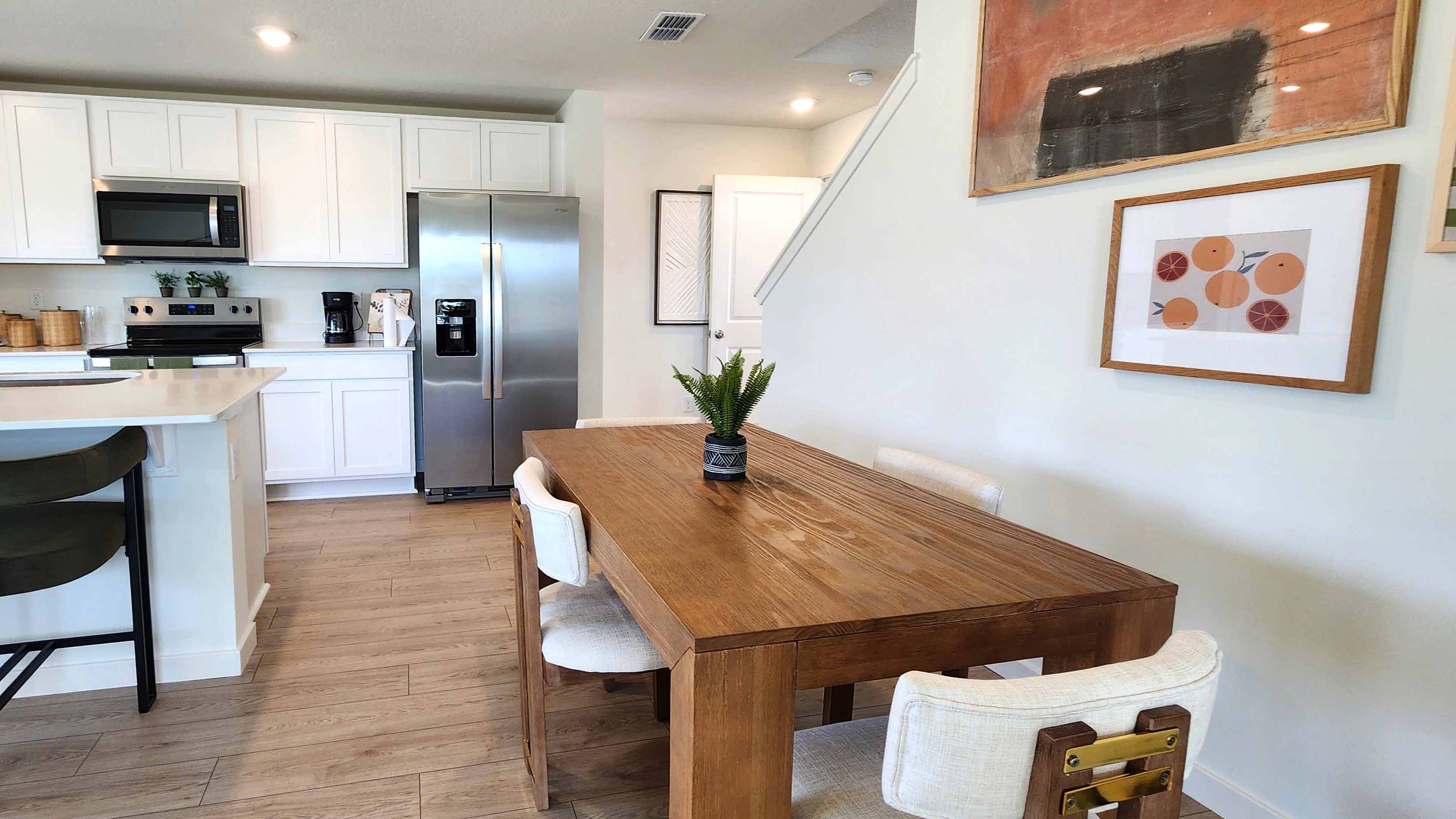 Dining room area with table, seating and natural lighting.