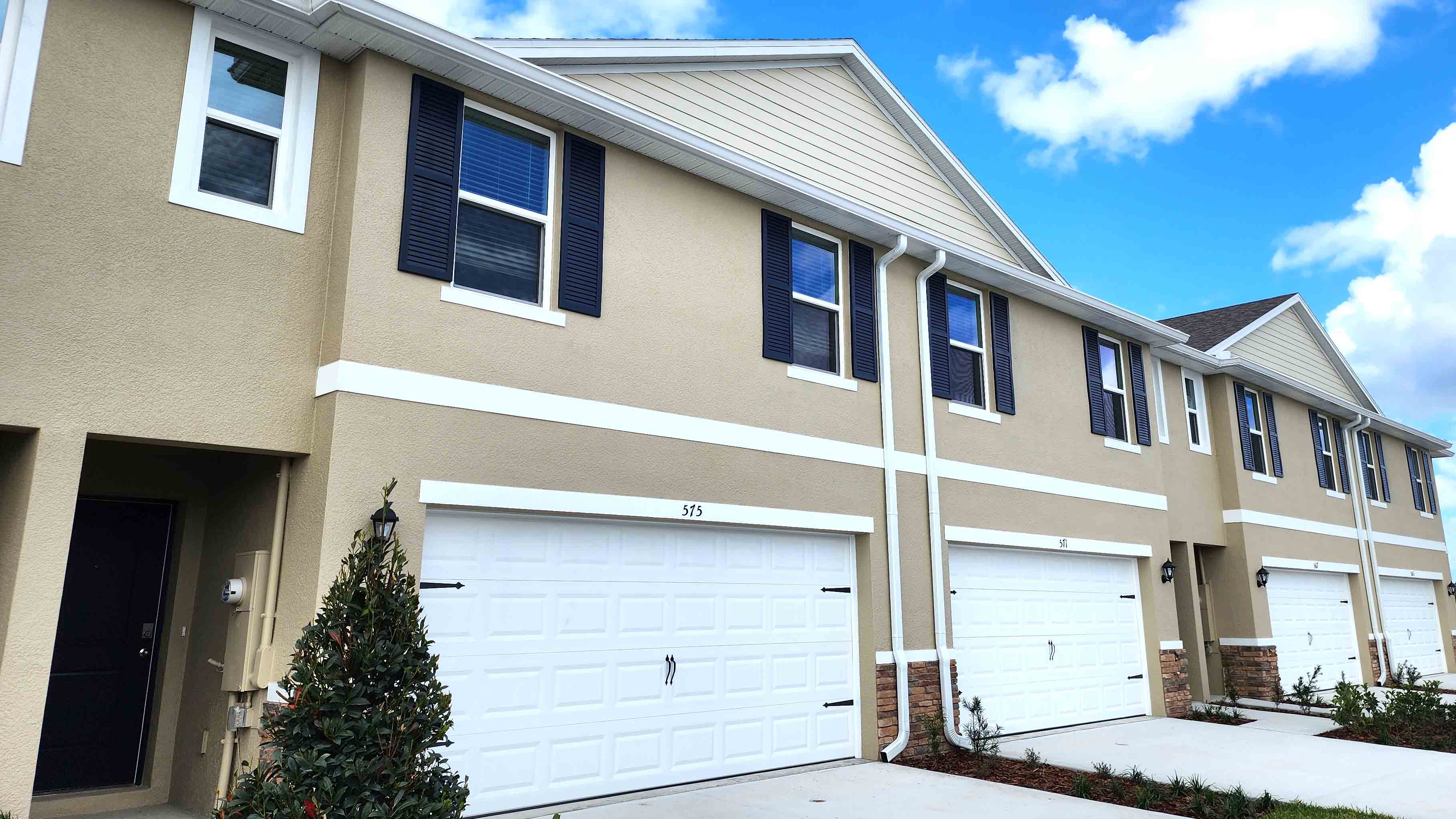 Attached townhome with concrete block construction and a one-car garage.