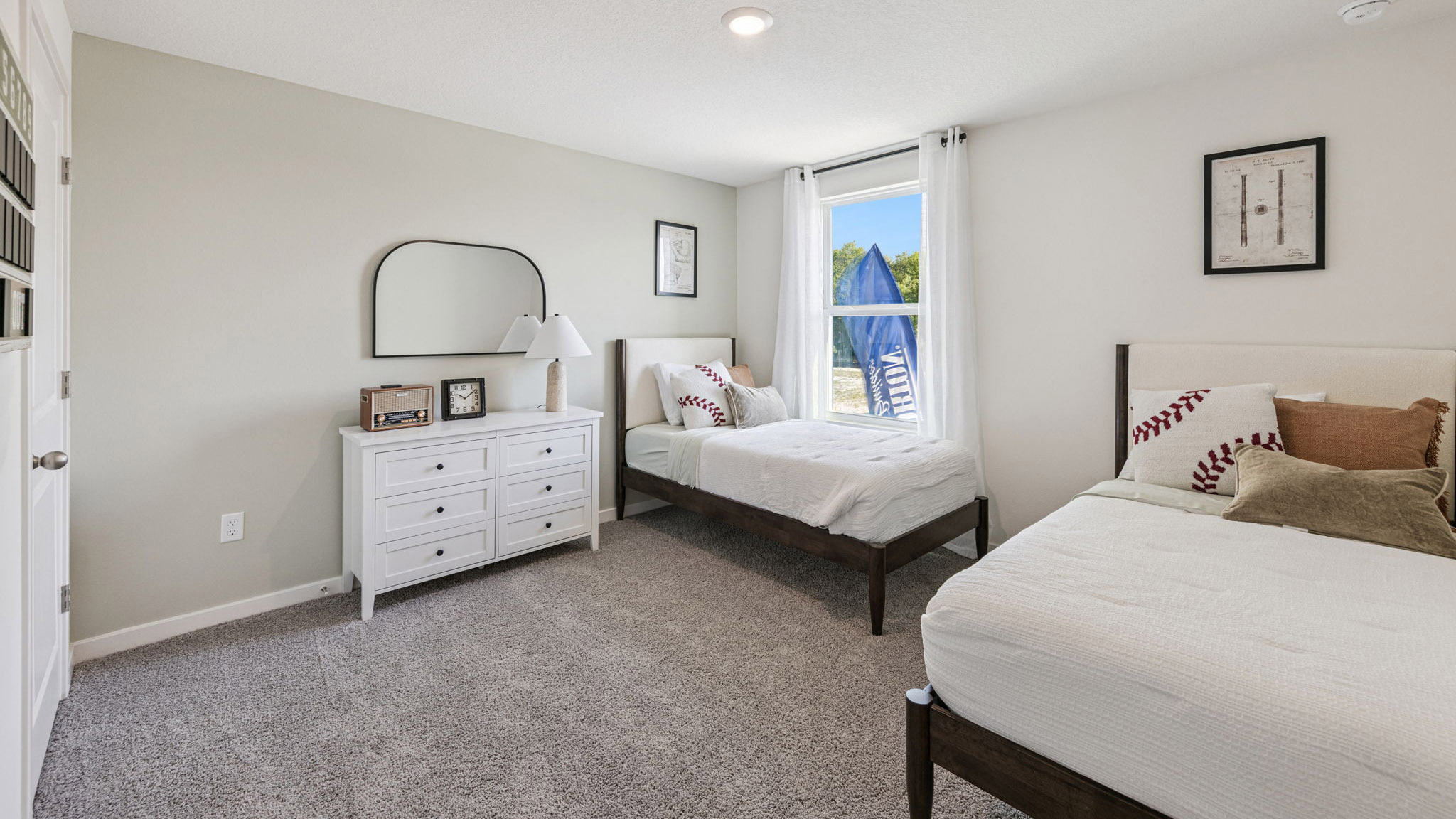 Guest bedroom with bed, nighstands and natural lighting.