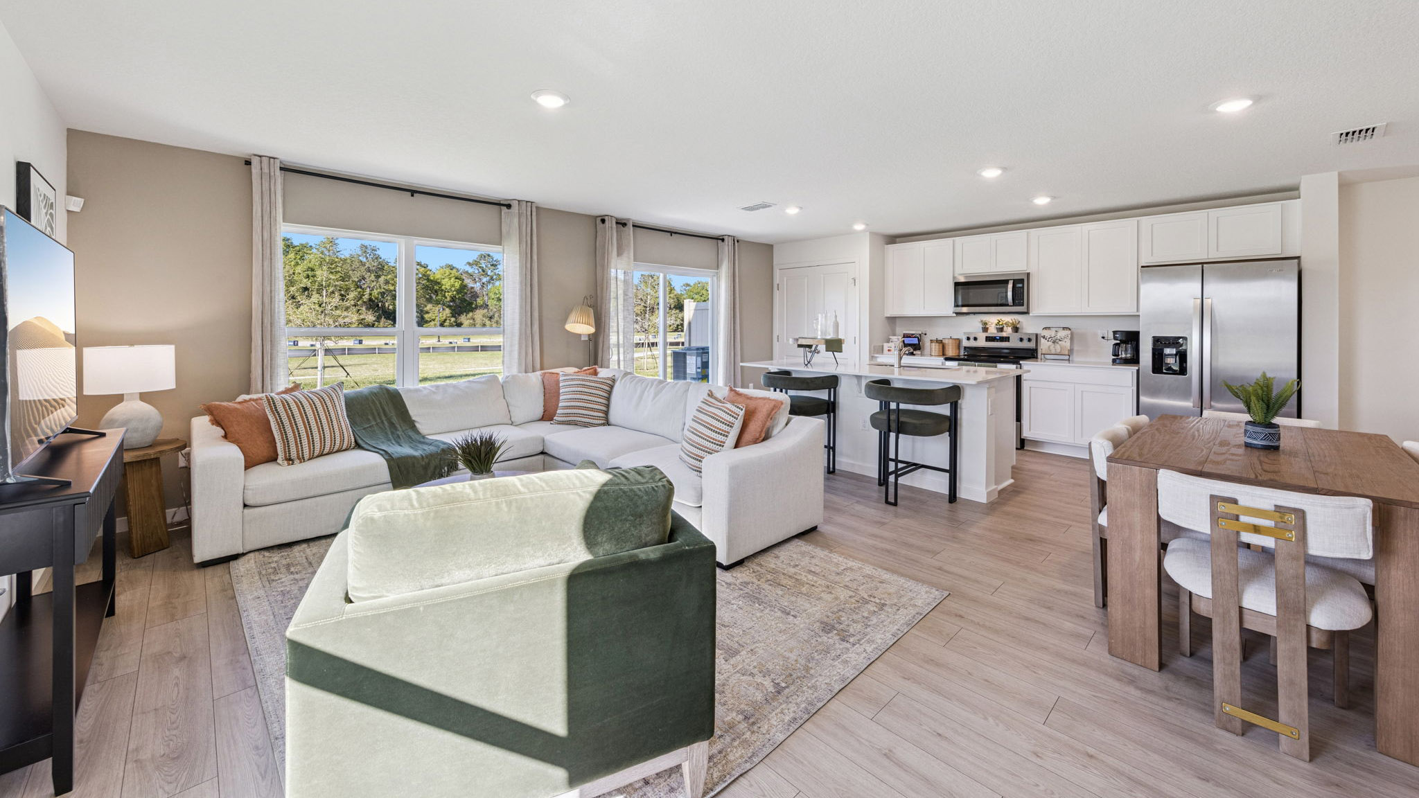 Living area with couch seating, entertainment system and natural lighting