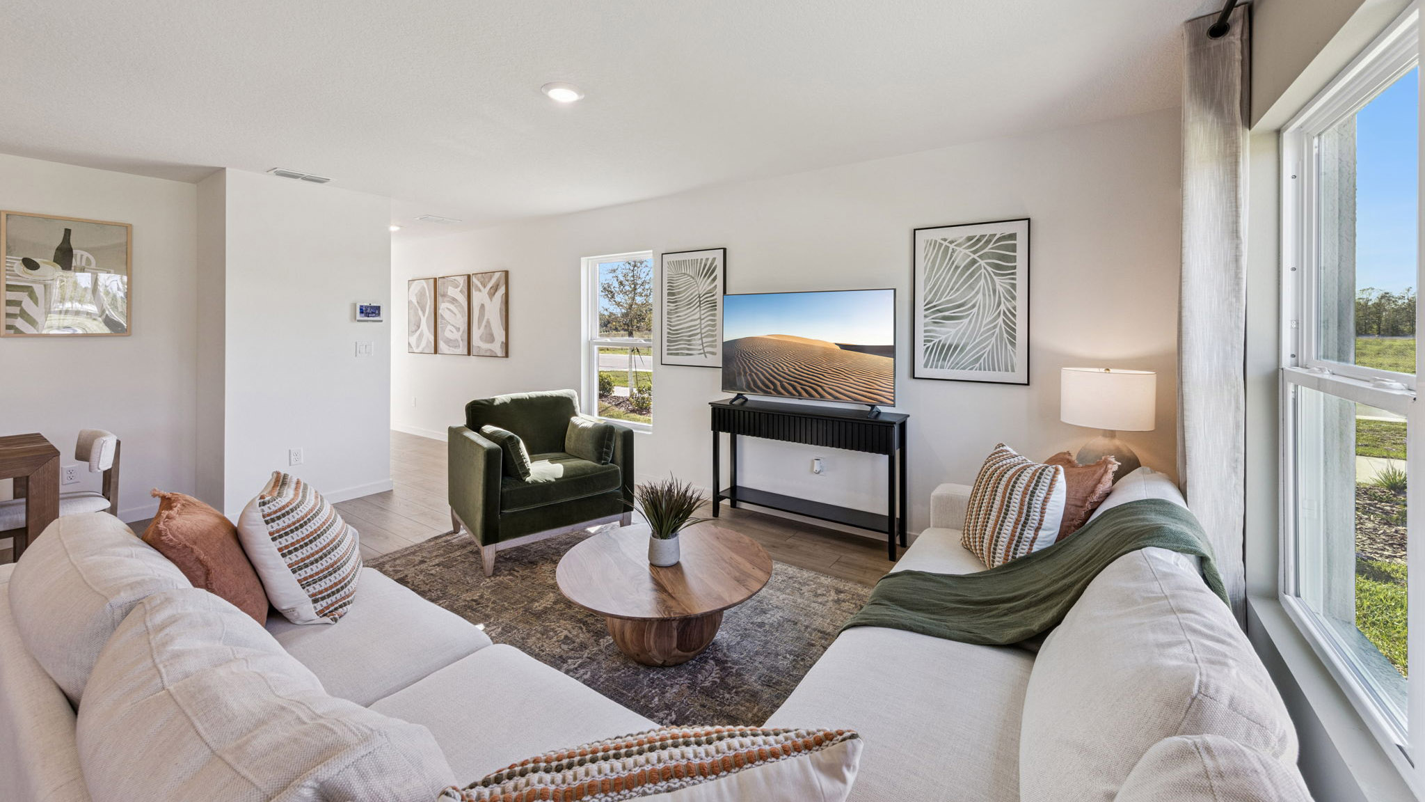Living area with couch seating, entertainment system and natural lighting