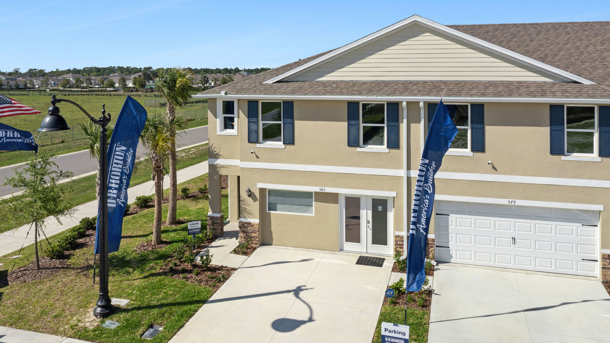 Single story new home with large windows and 2 car garage.